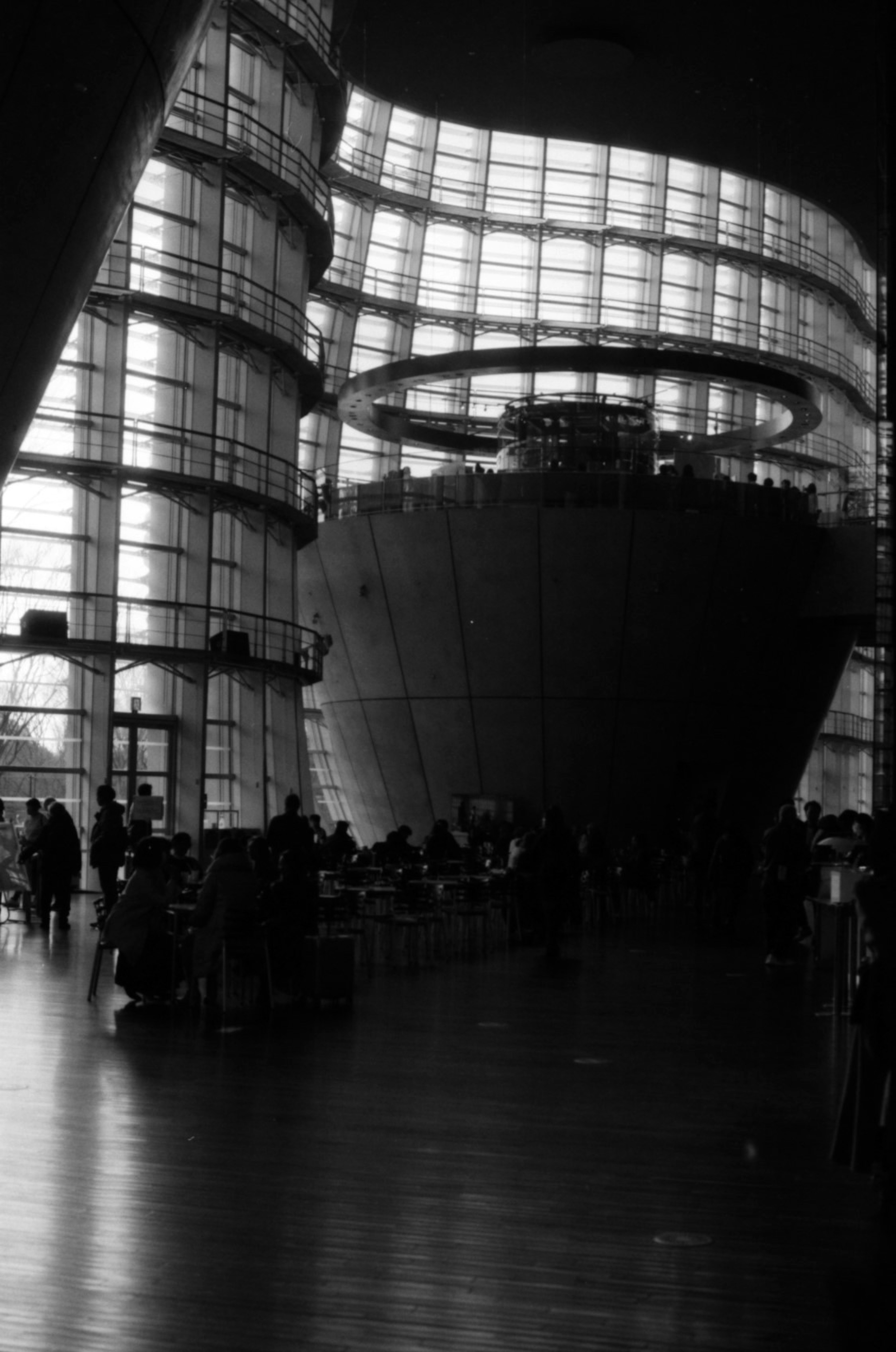 Interior of modern architecture featuring expansive space large glass walls and curved design