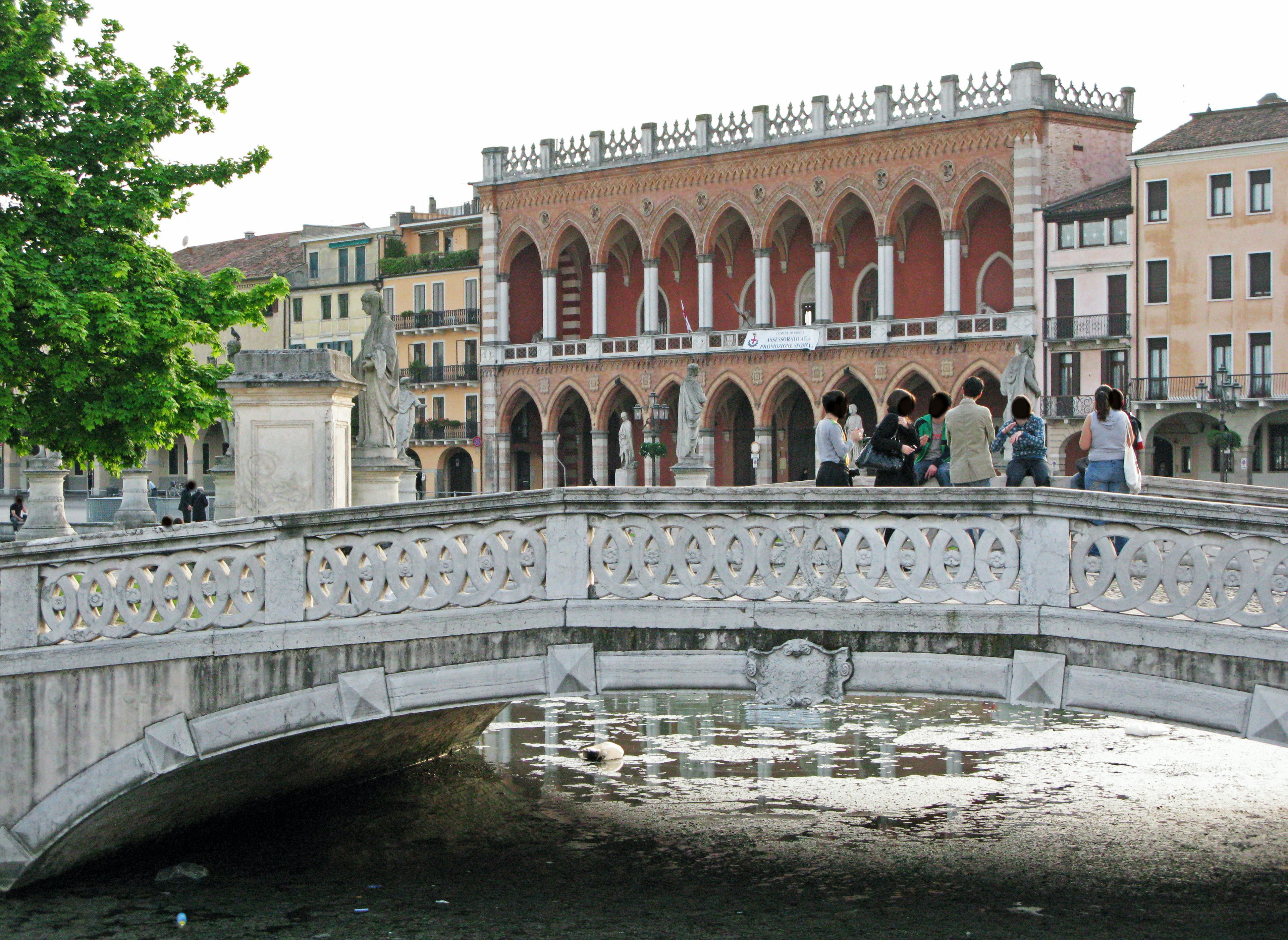 Scenic view of an arch bridge and red brick building