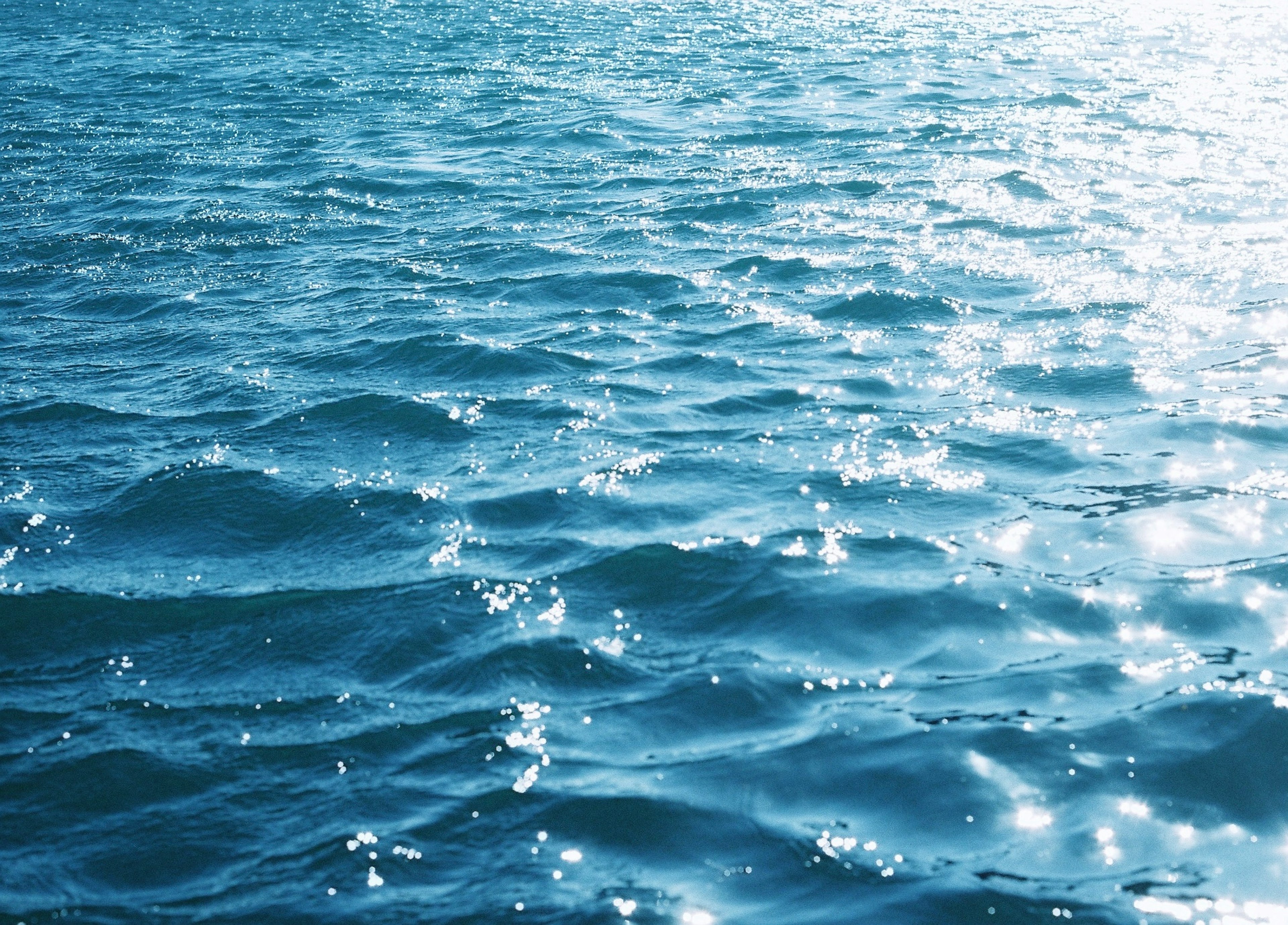 Rippling blue ocean water with sparkling reflections