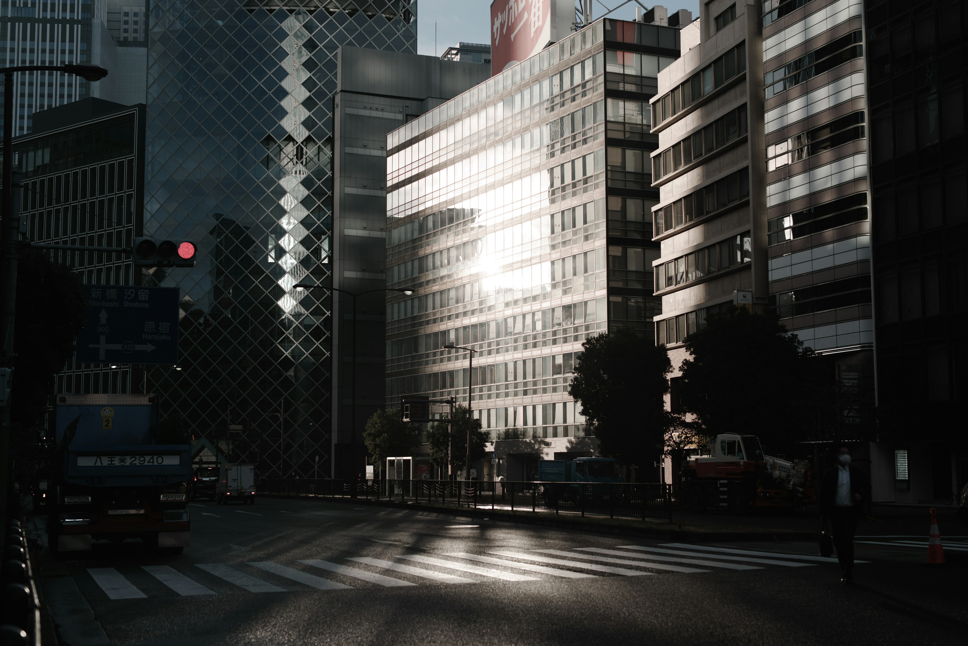 Urban skyline with buildings and intersection at dusk reflecting light