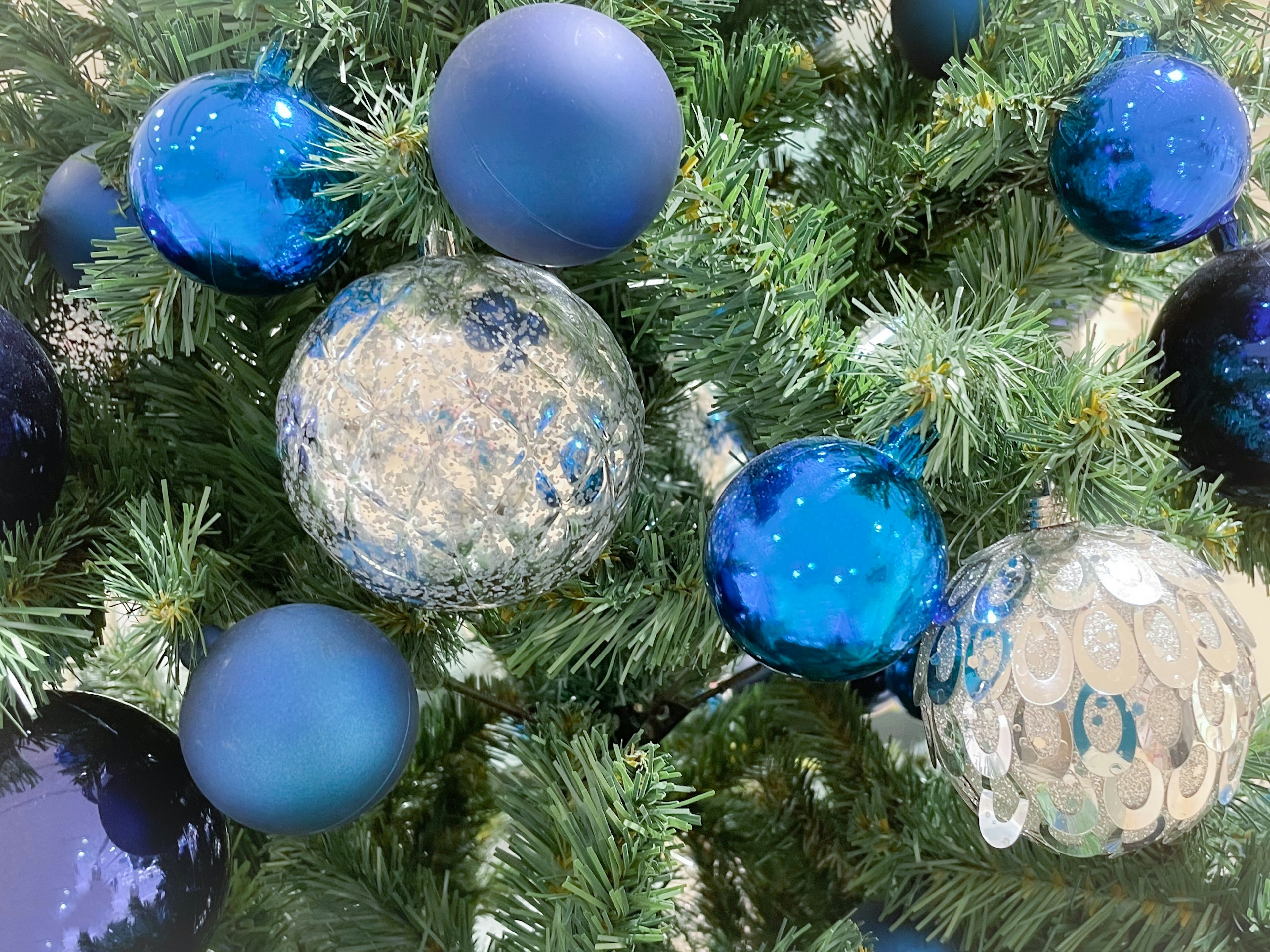 Christmas tree adorned with blue and silver ornaments