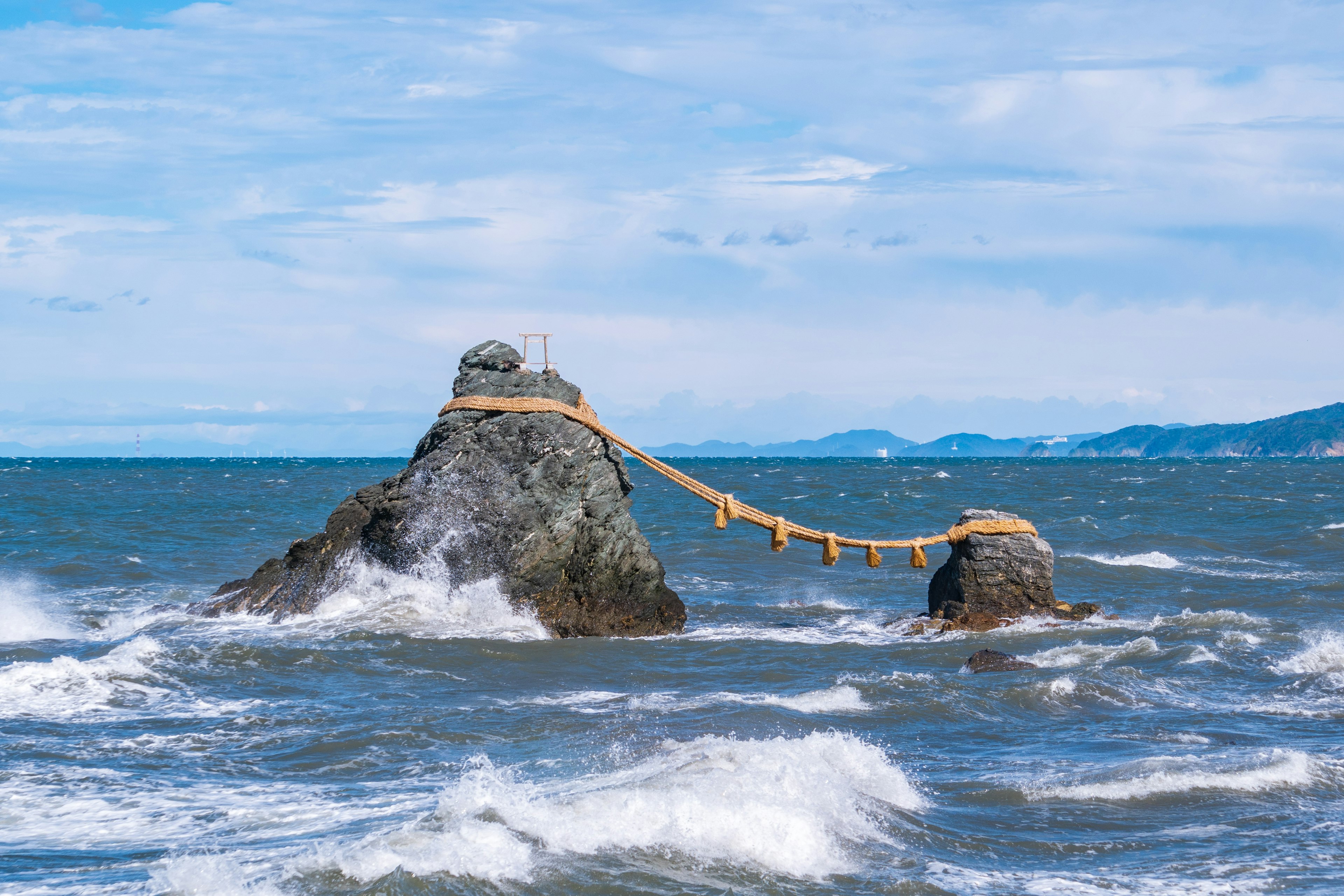 Rocks in the ocean connected by a sacred bridge