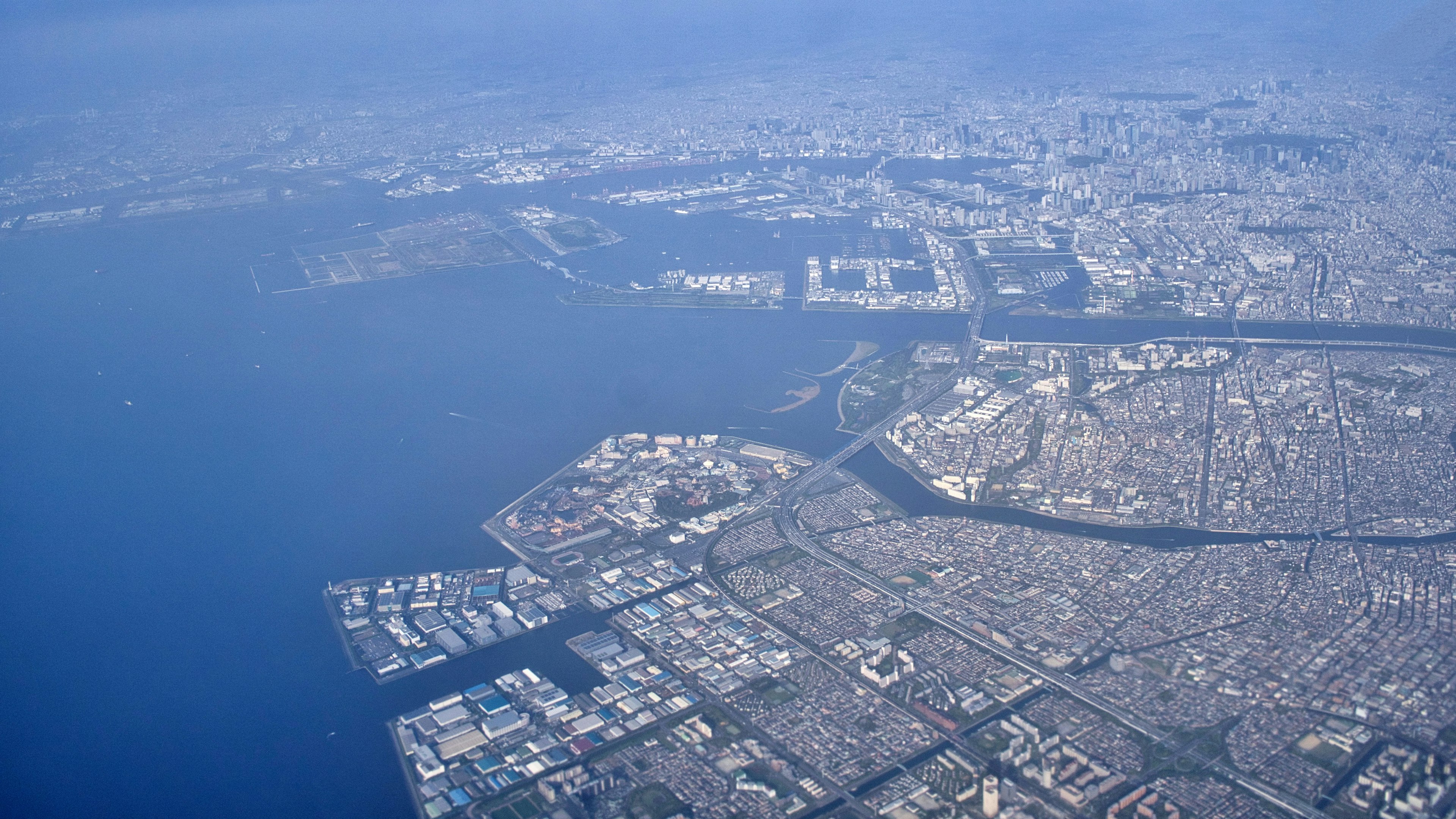 Aerial view of a coastal city with urban landscape and waterways