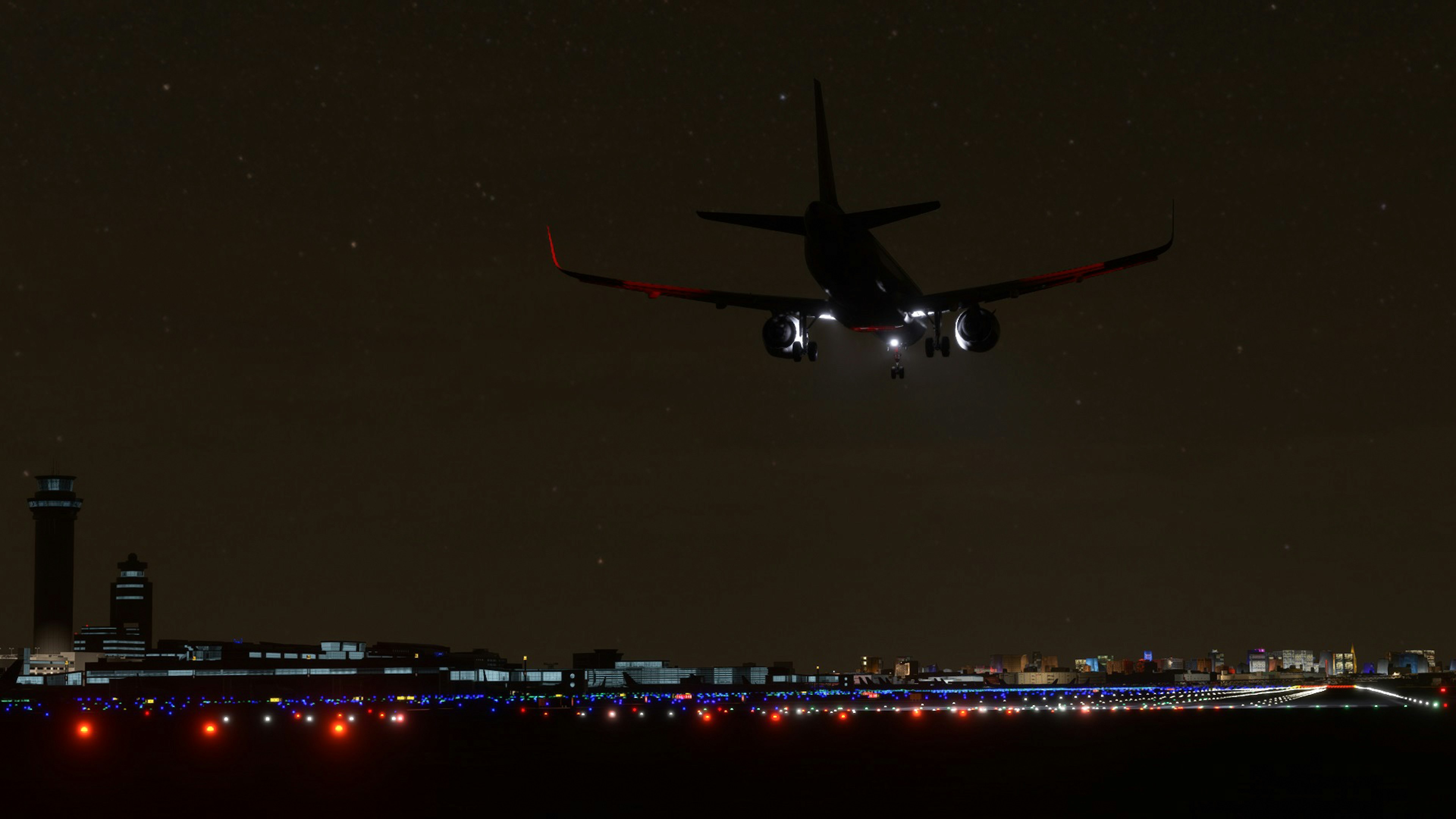 Flugzeug fliegt nachts mit Stadtlichtern darunter