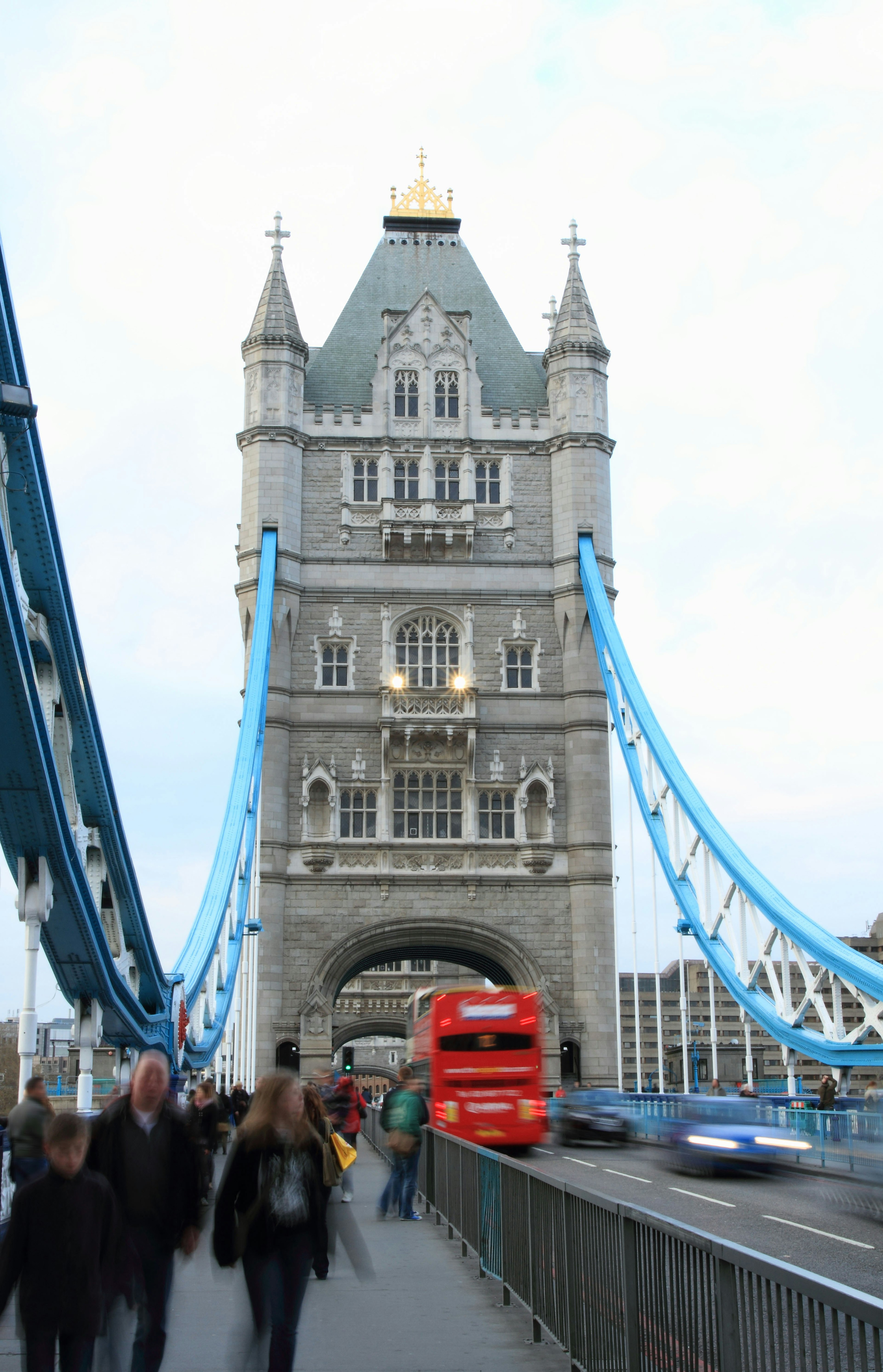 View of Tower Bridge with iconic red bus and pedestrians