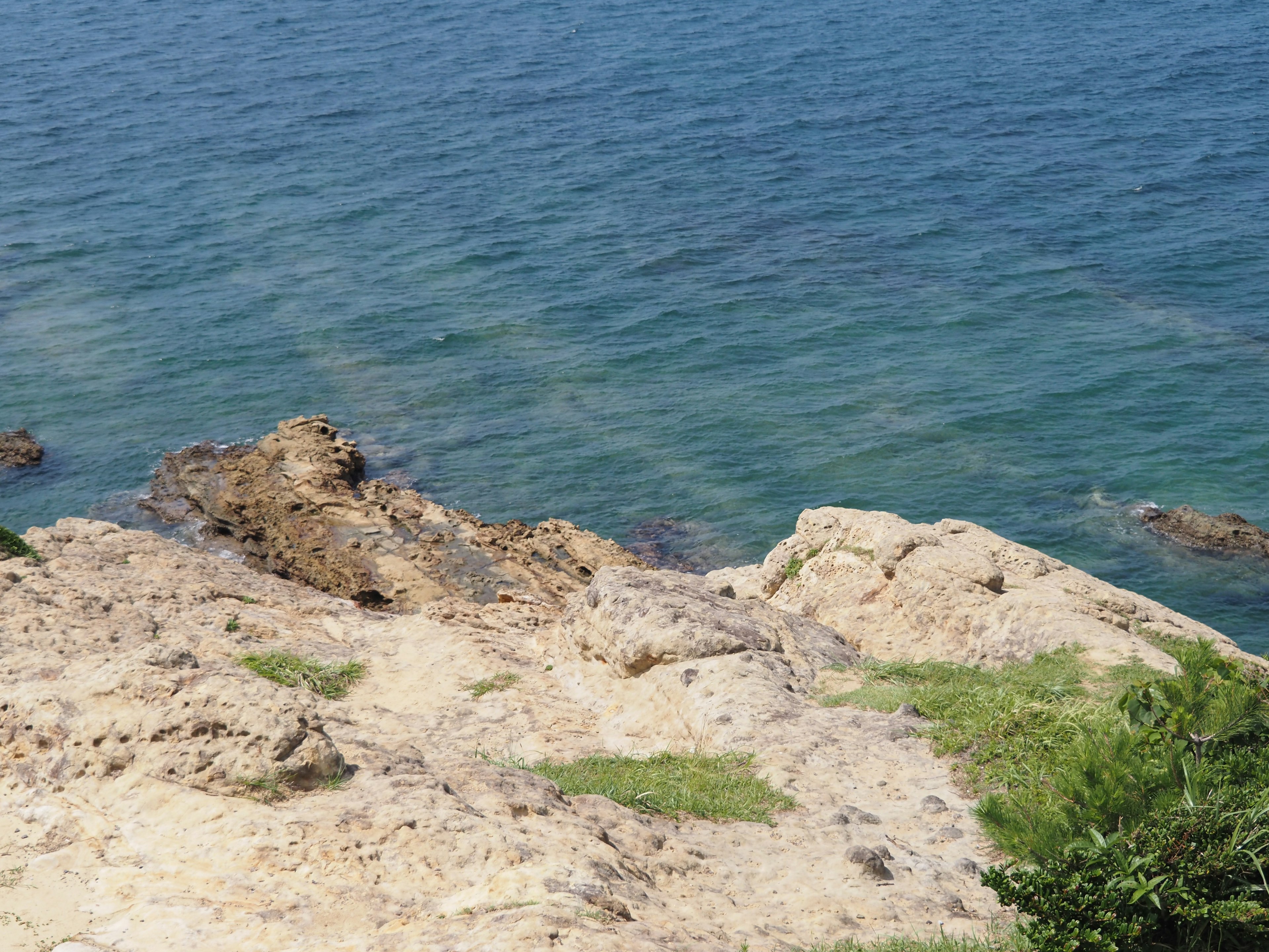 Coastal landscape featuring blue sea and rocky shoreline