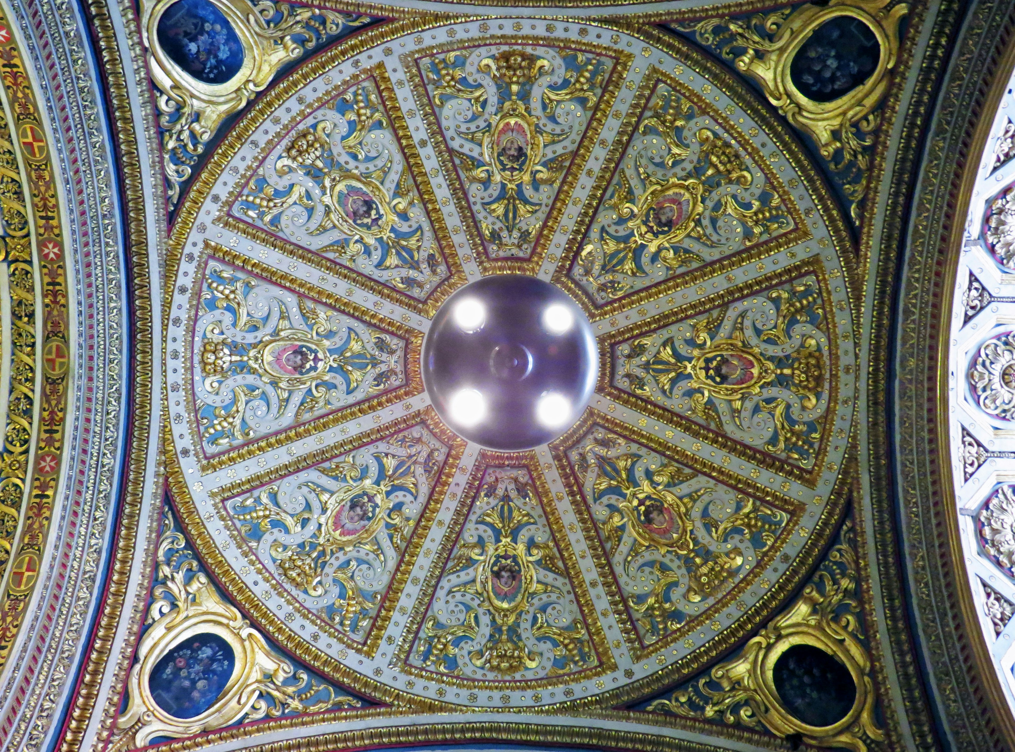 Ornate ceiling design with intricate patterns and central lighting