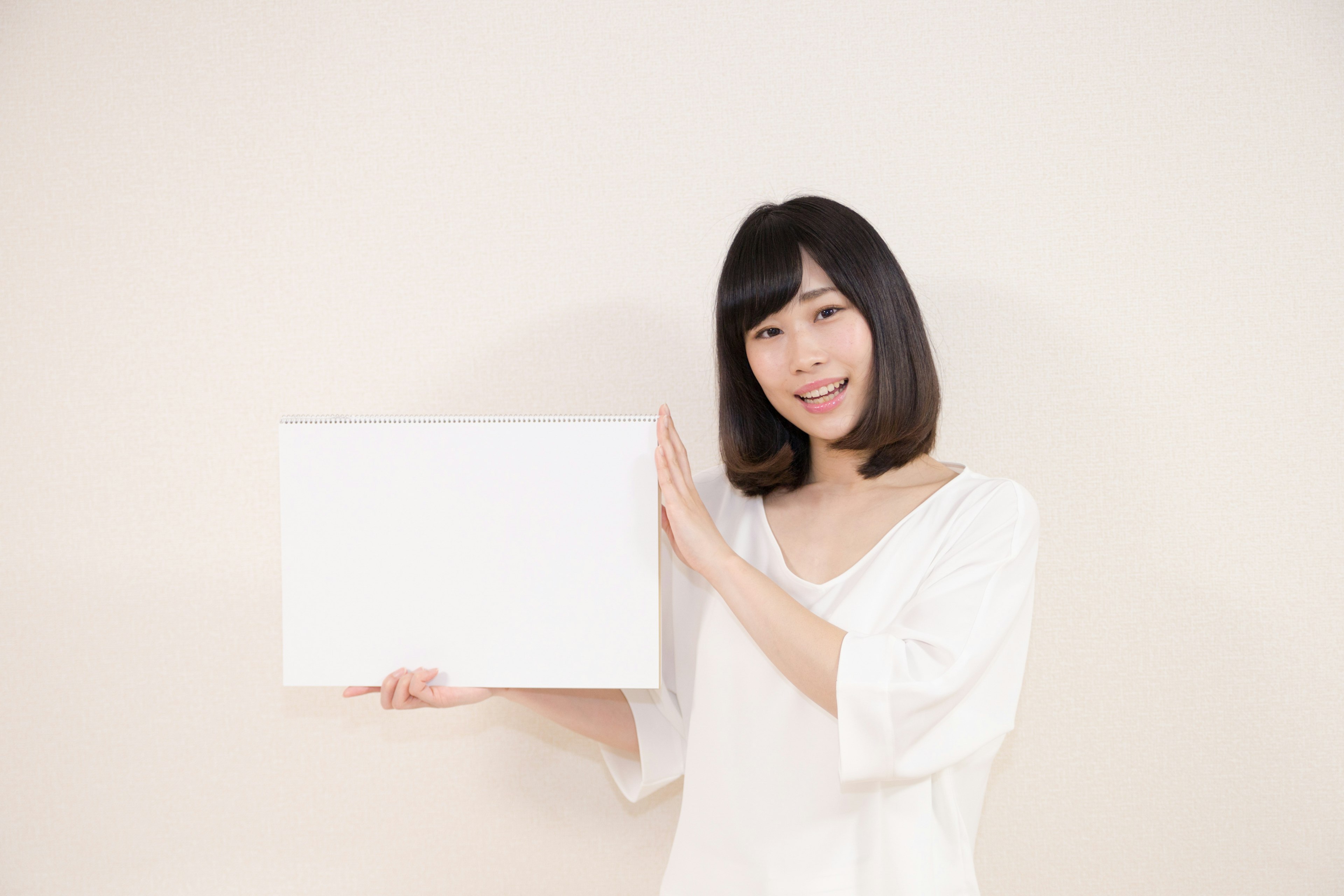 Smiling woman holding a white box