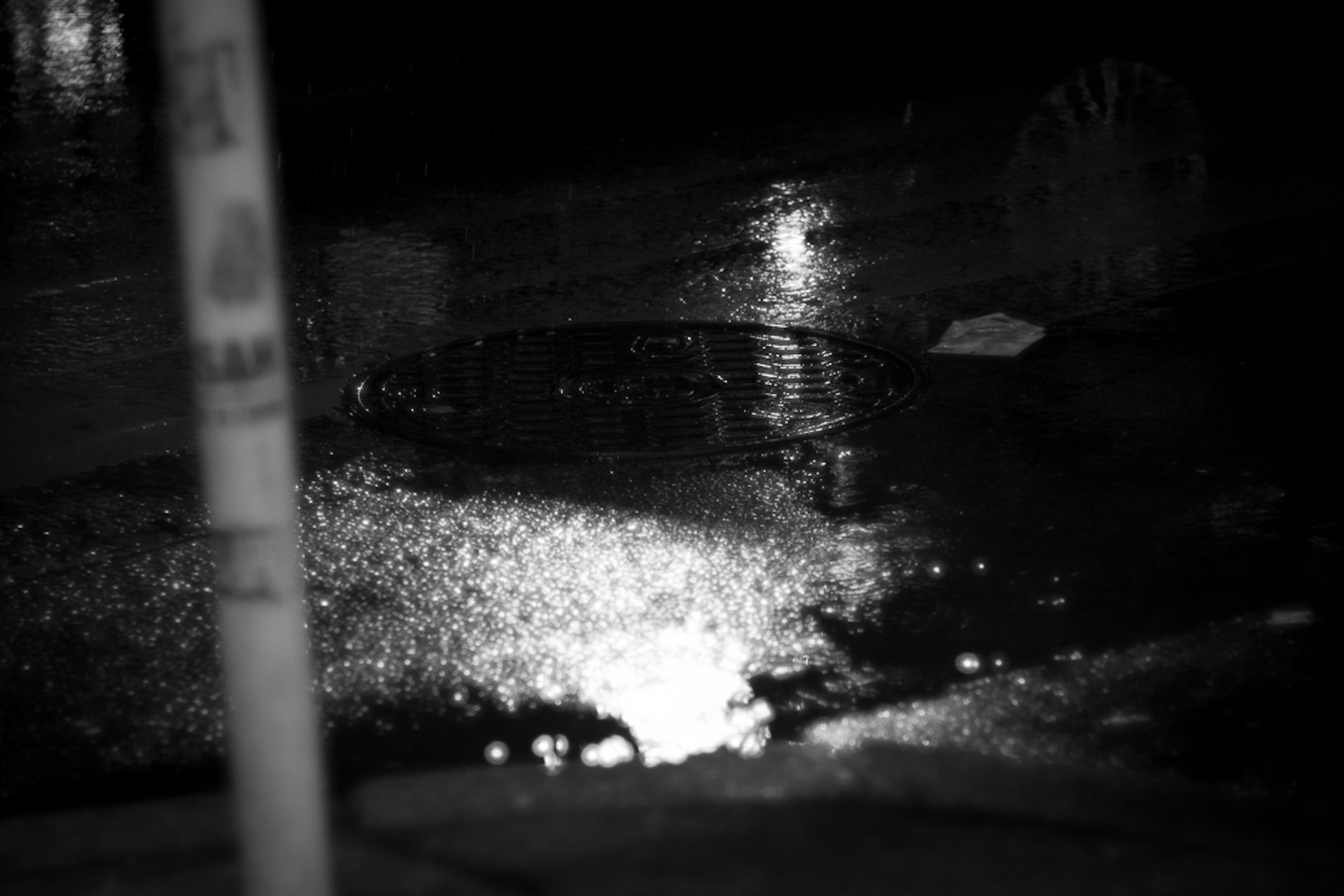 Reflection of light in a puddle on a dark street