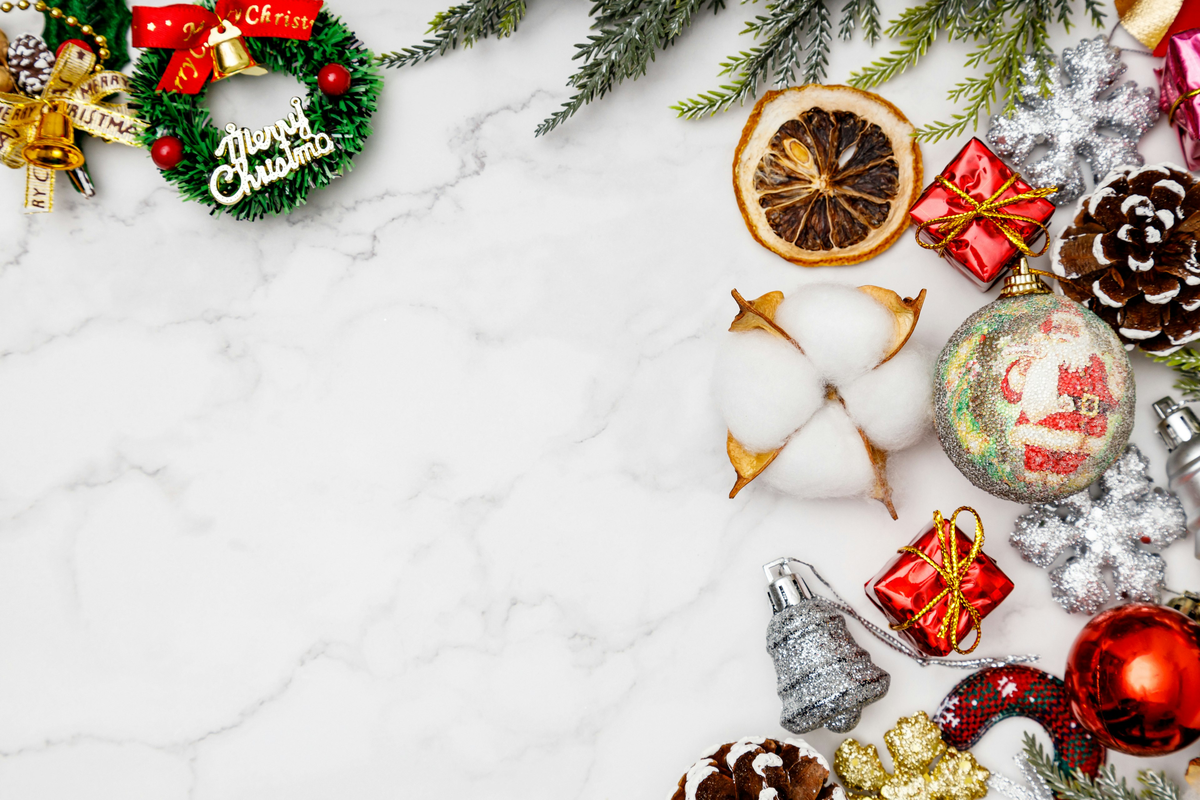 Christmas decorations and gifts arranged on a white marble background