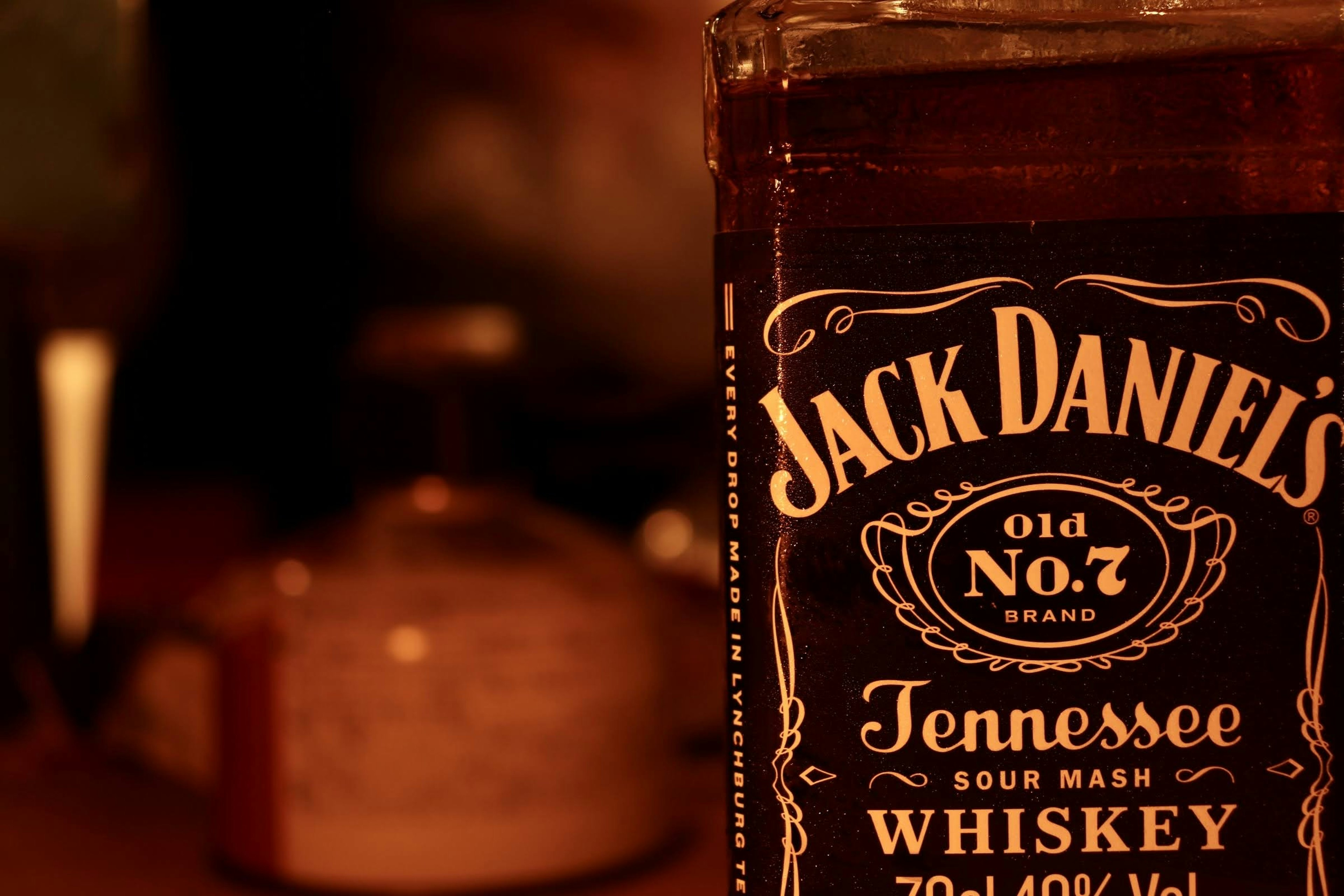 Jack Daniel's whiskey bottle in the foreground with a blurred background