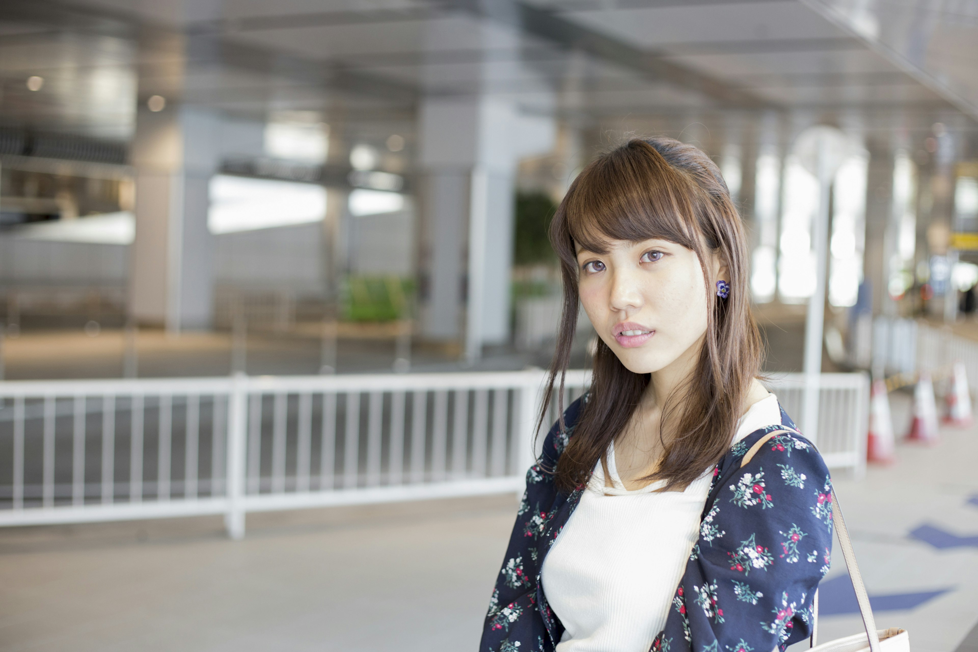 A woman wearing floral clothing in an indoor setting