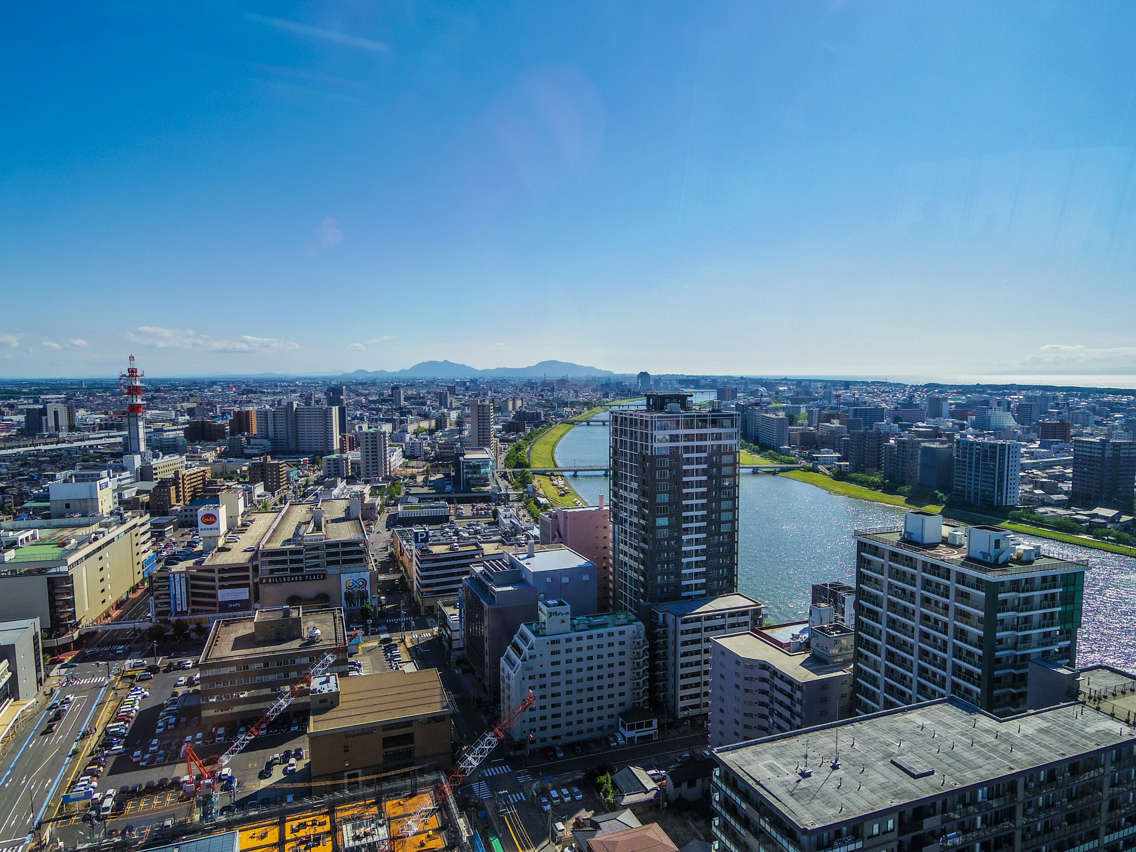 Panoramablick auf eine Stadt mit Wolkenkratzern Fluss und blauem Himmel