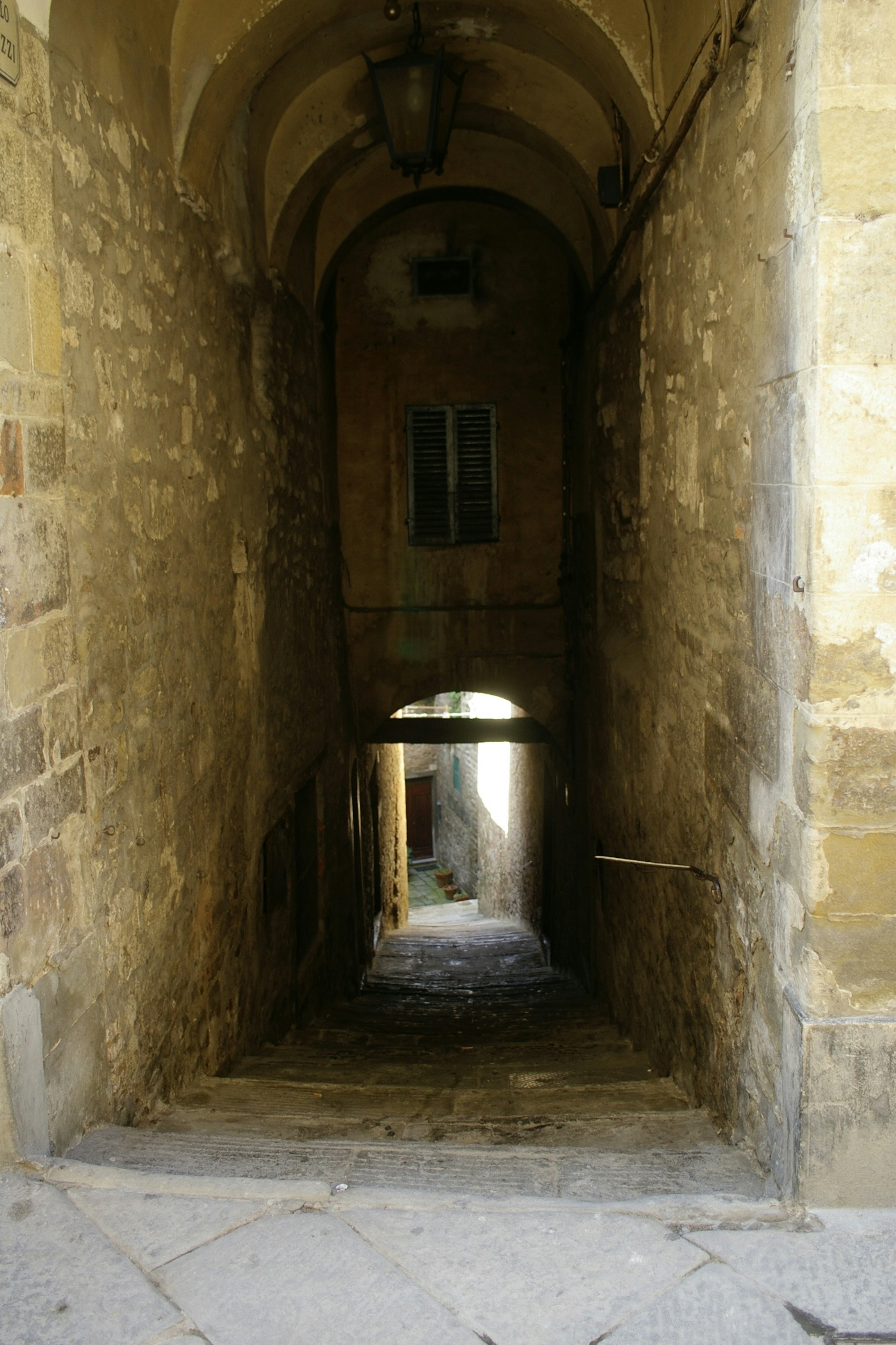 Photo of a dark passageway with stone stairs