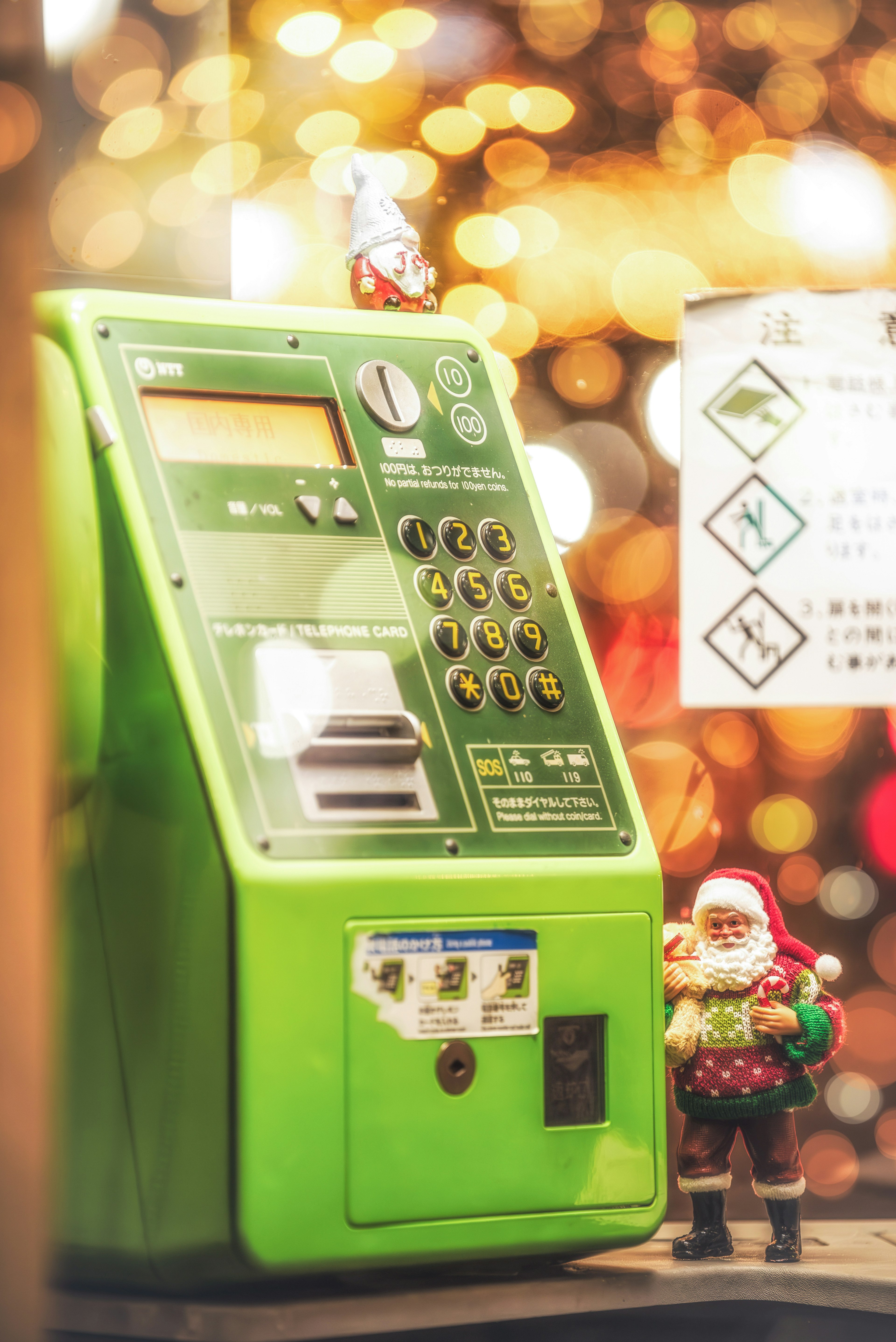 Green vending machine with Santa figurine in a festive setting