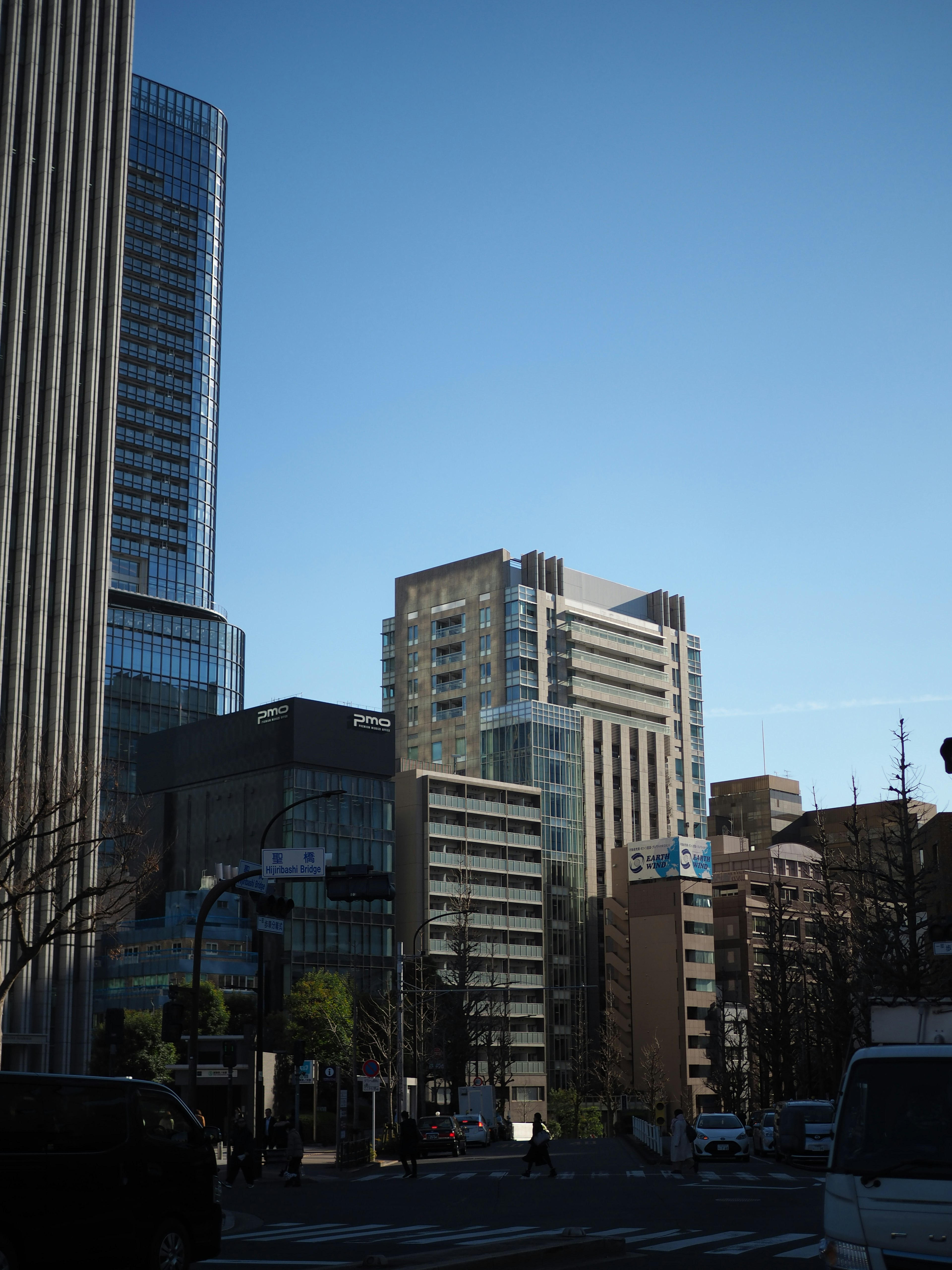 Urban landscape featuring tall buildings against a clear blue sky