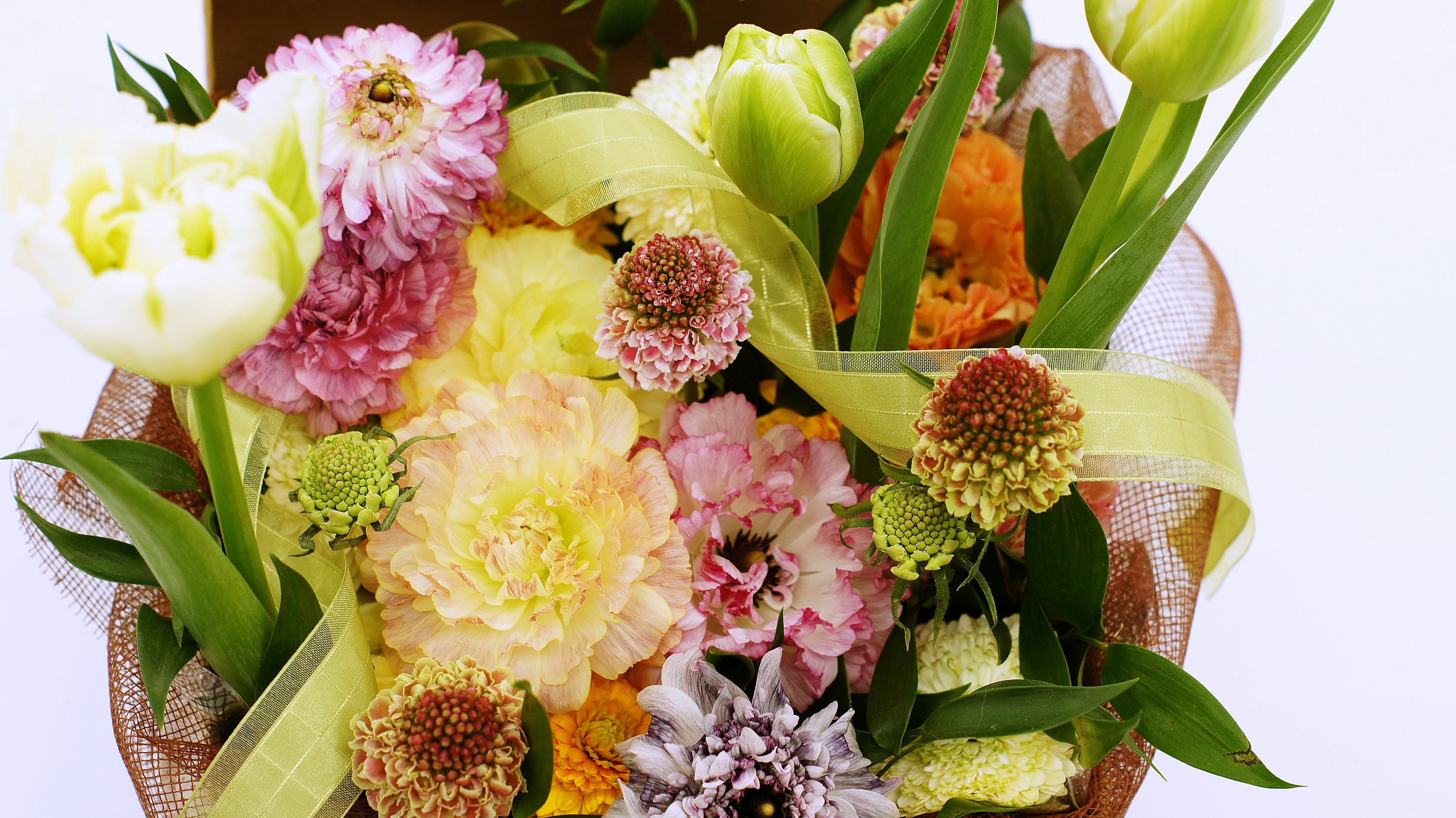 A beautiful arrangement of colorful flowers with a ribbon