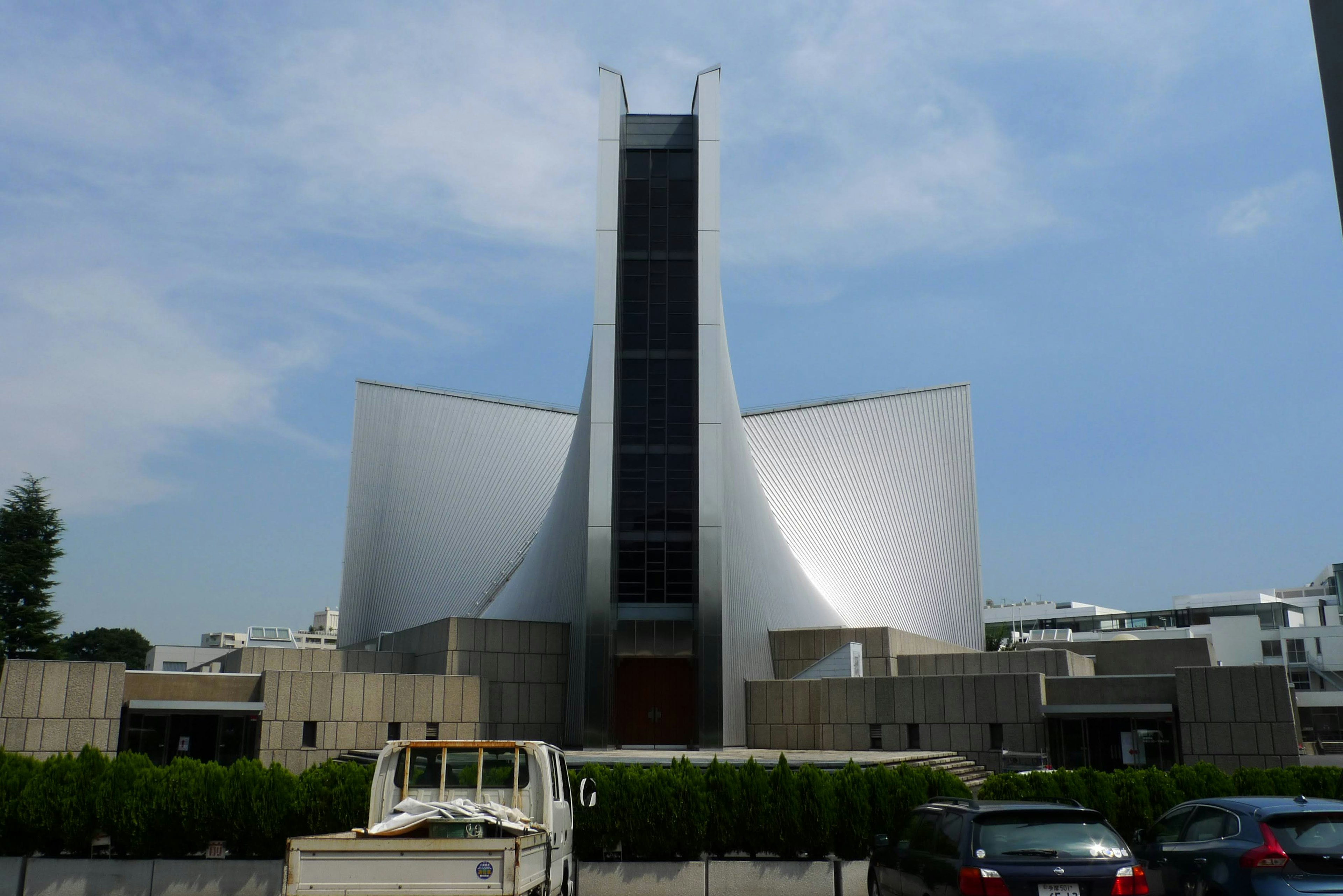 Modern church architecture with white curved design under blue sky