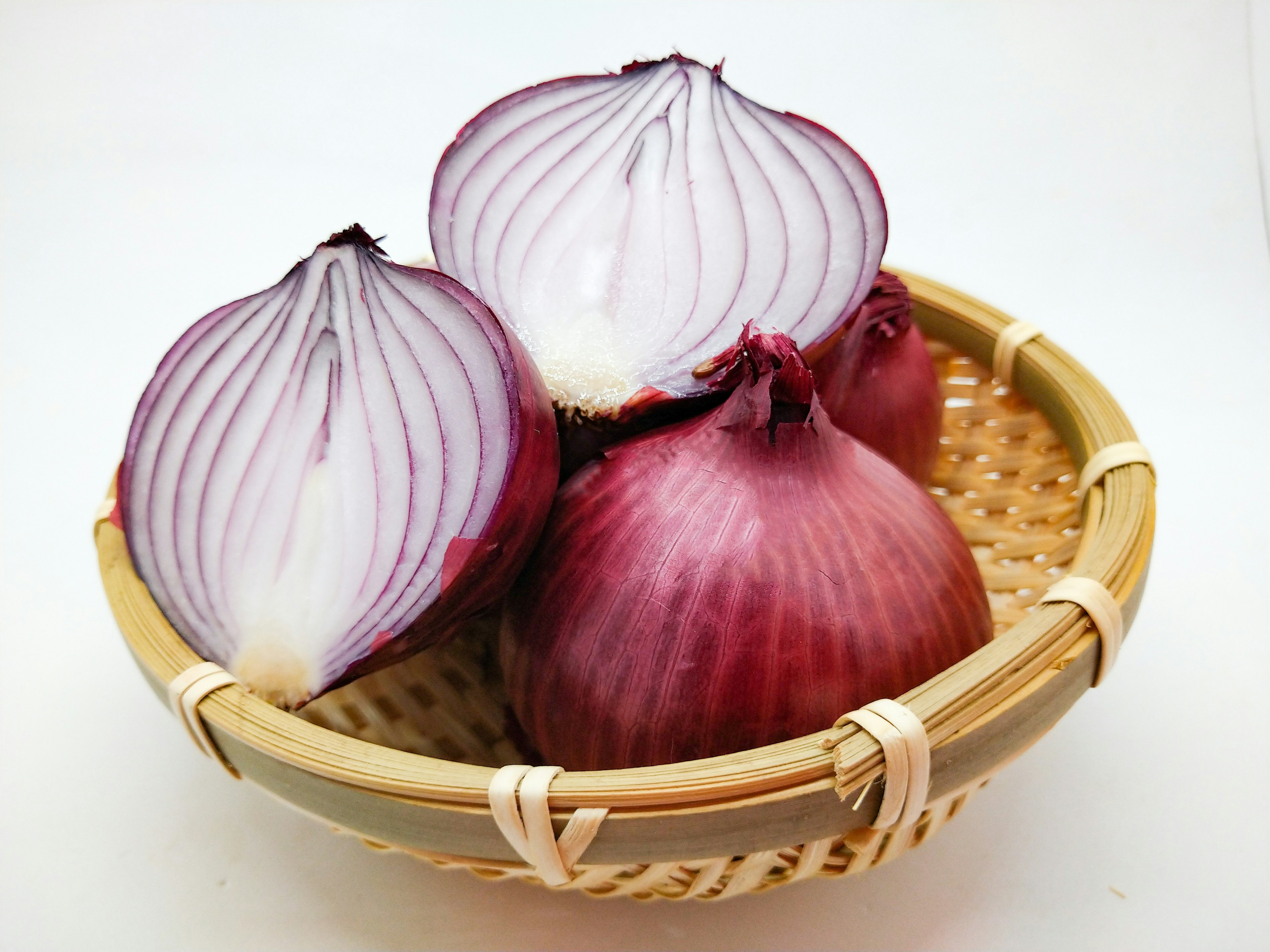 Red onions in a woven basket