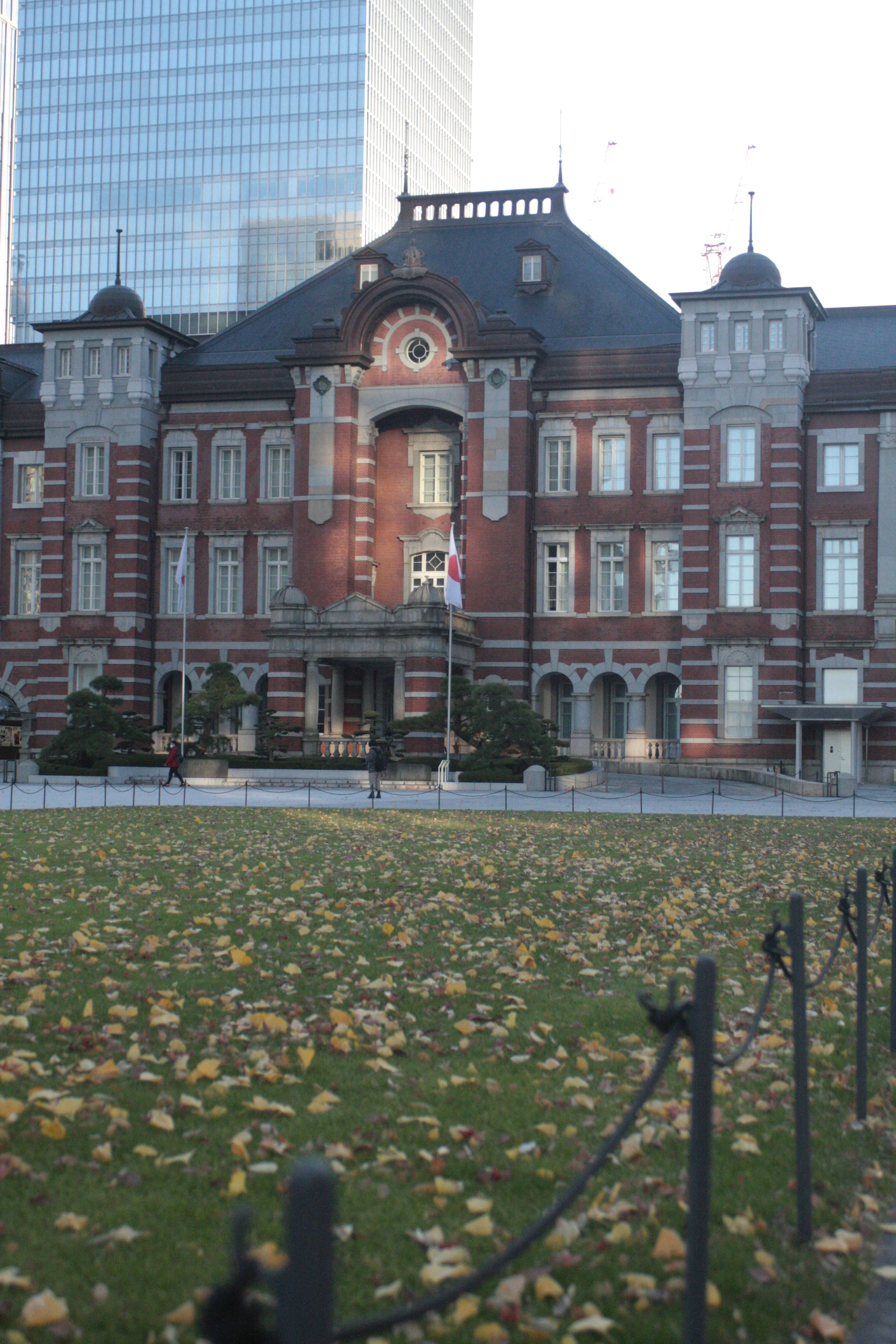 Historic Tokyo Station building with surrounding park landscape