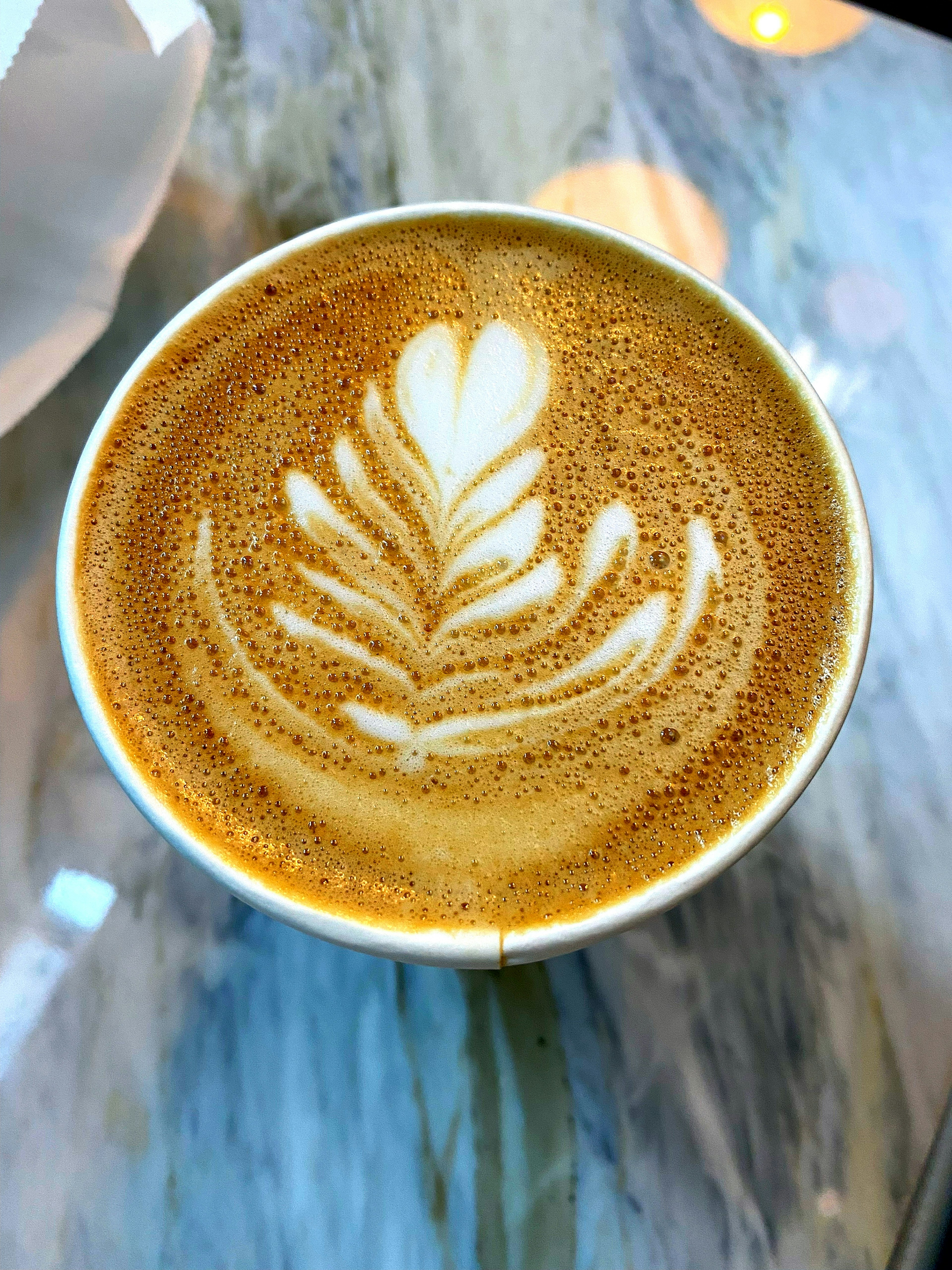 Coffee cup with intricate latte art design