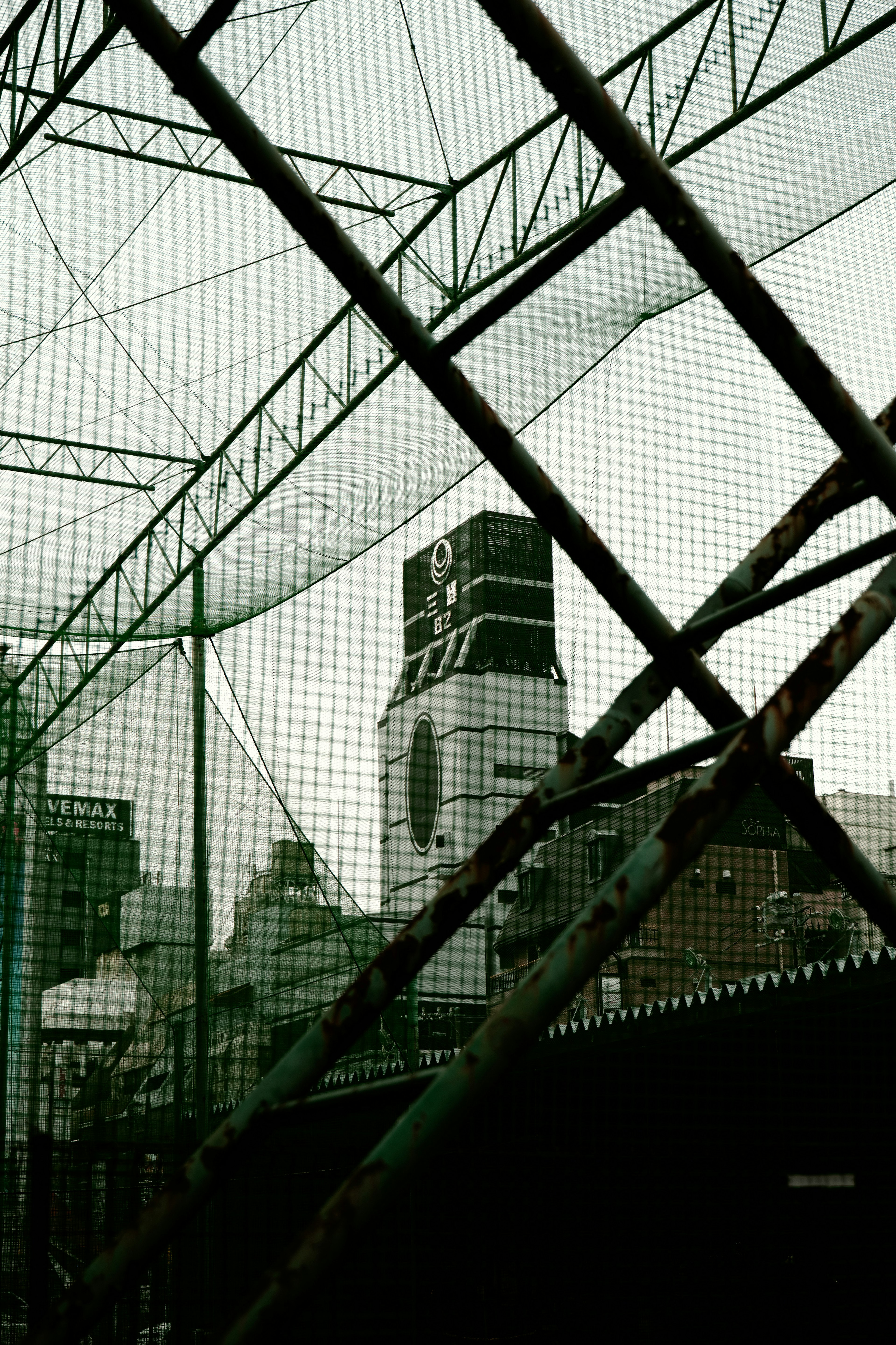 Photo of buildings and structures viewed through a net