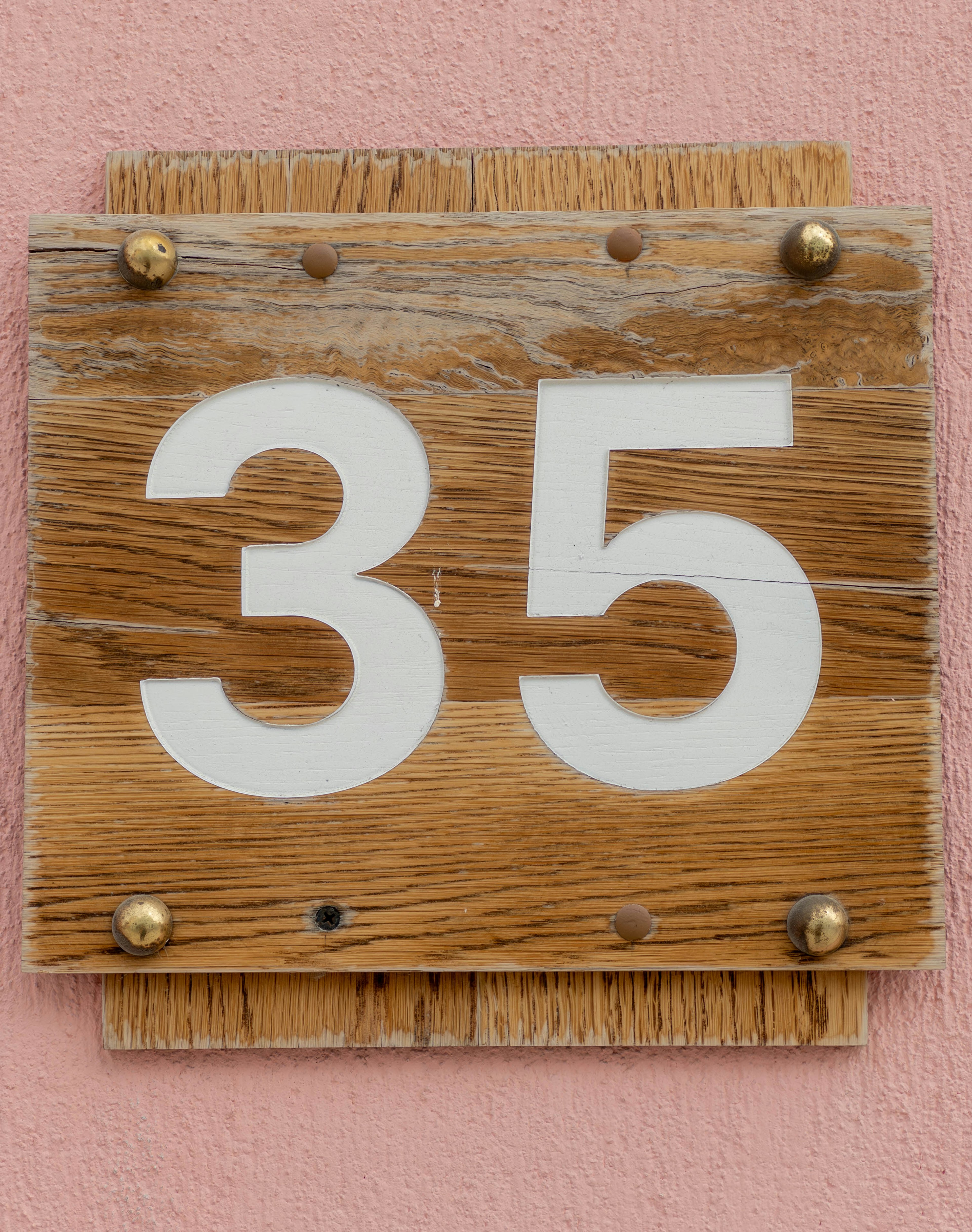 Wooden sign displaying the number 35 in white