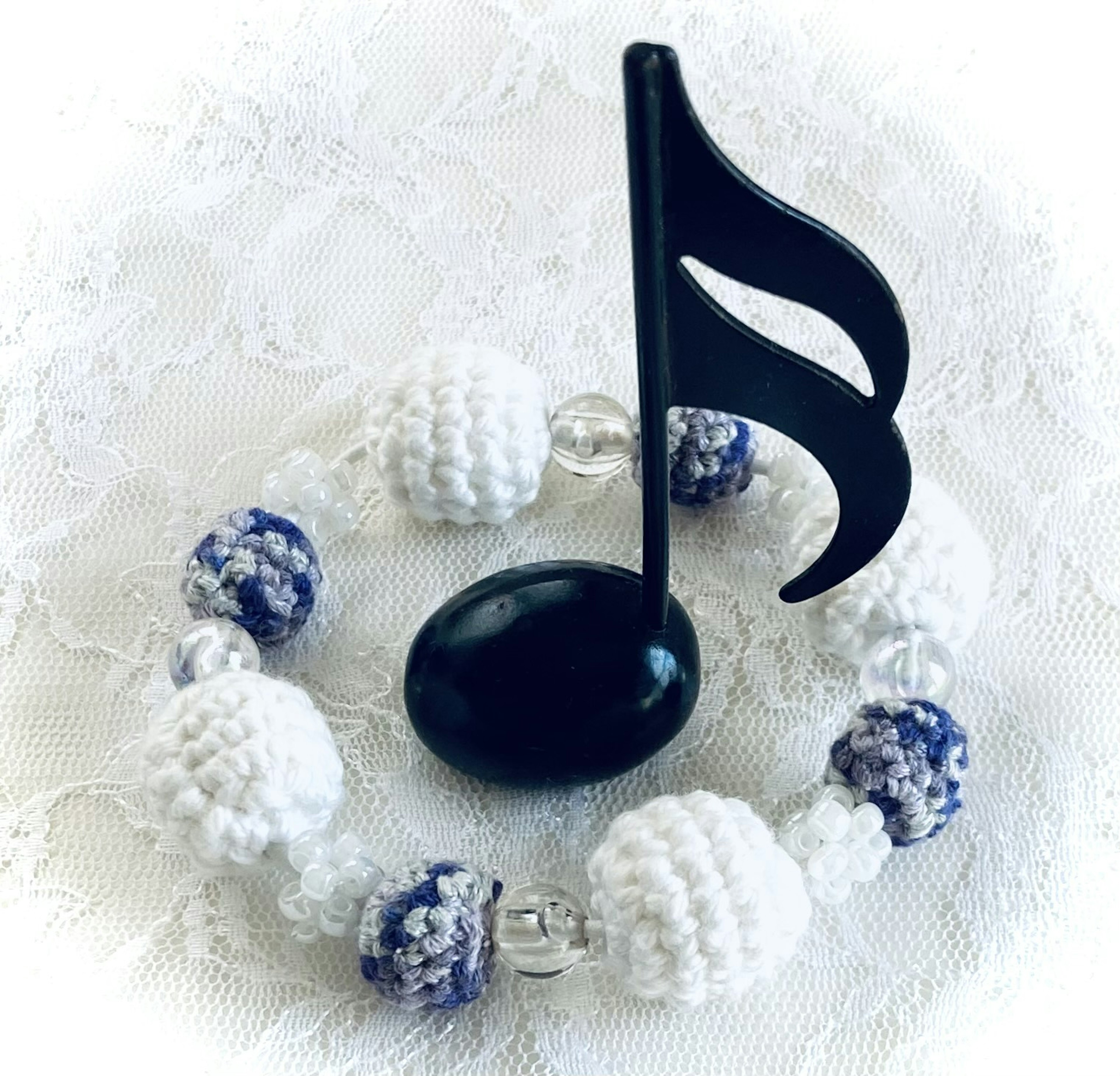 Decorative musical note stand with white and blue beads