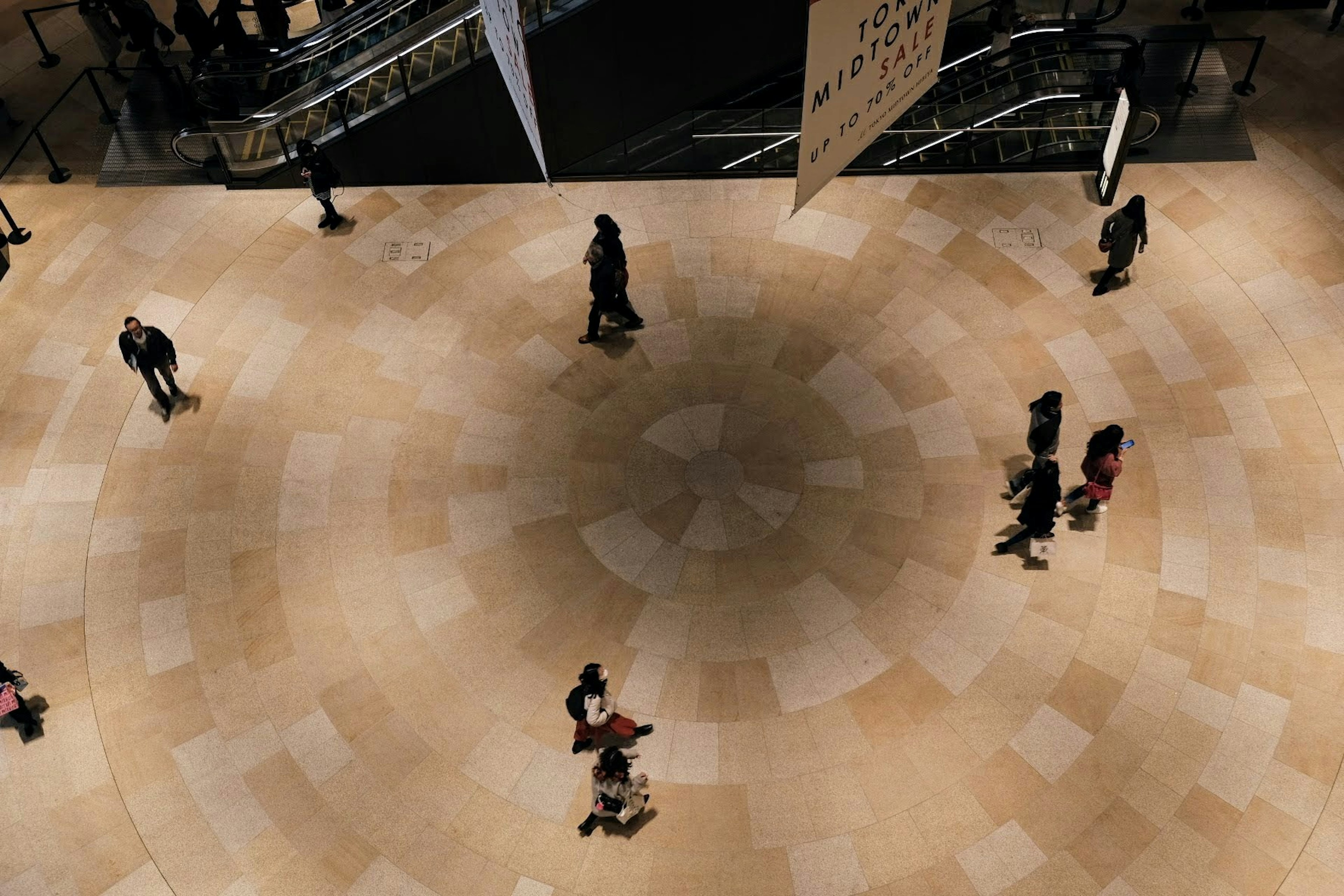 Aerial view of people walking on a circular floor