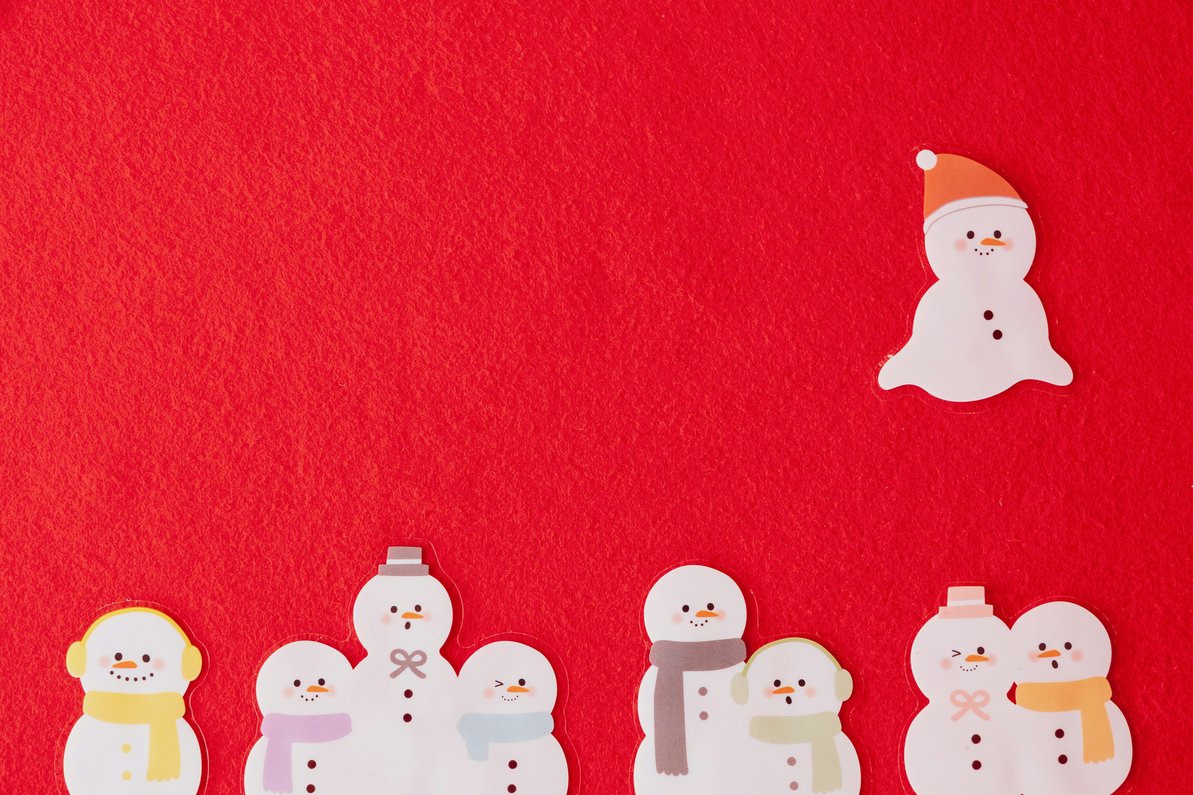 A collection of cute snowman illustrations on a red background