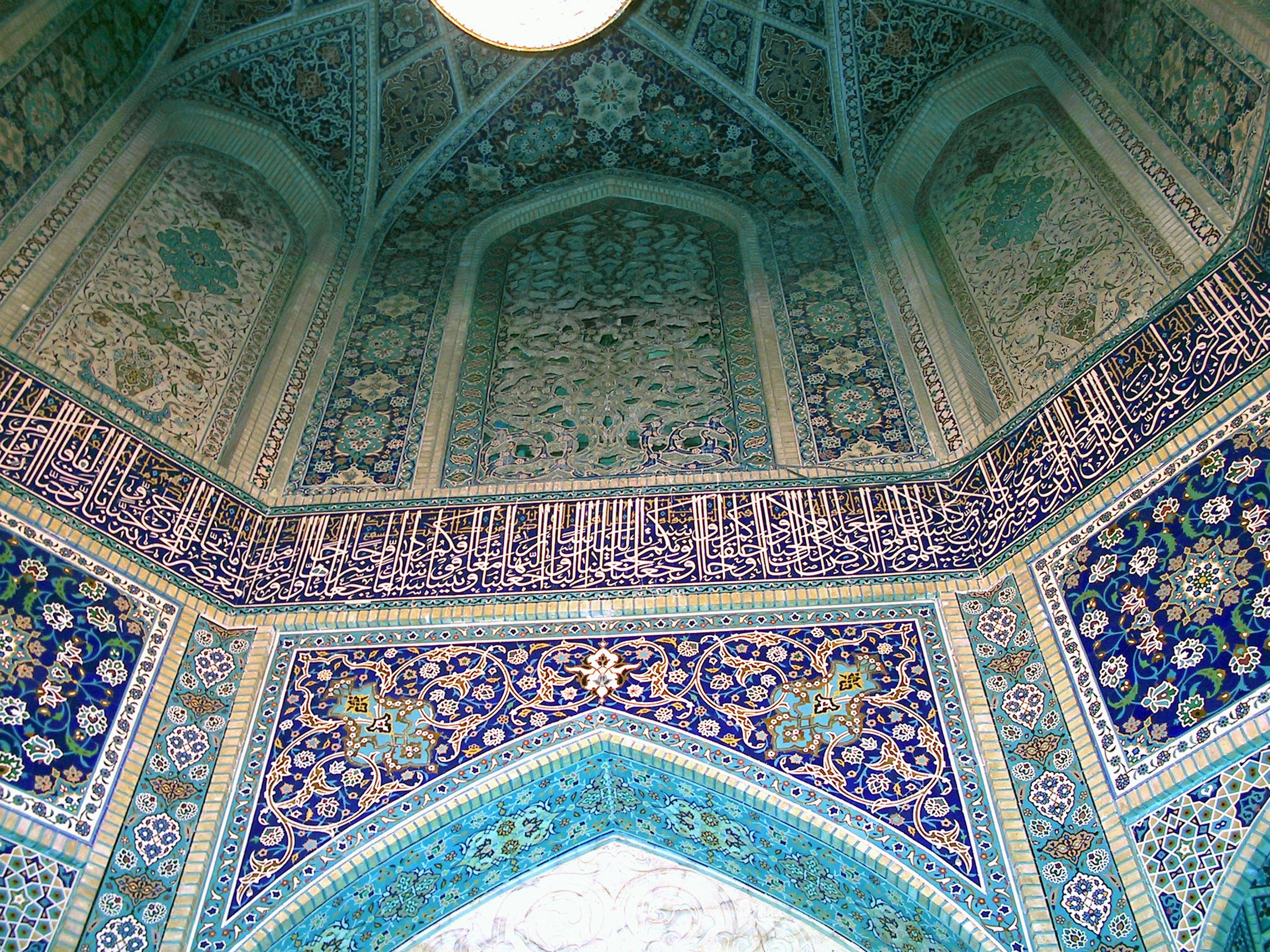 Intricate blue and green tile decorations on an arching ceiling