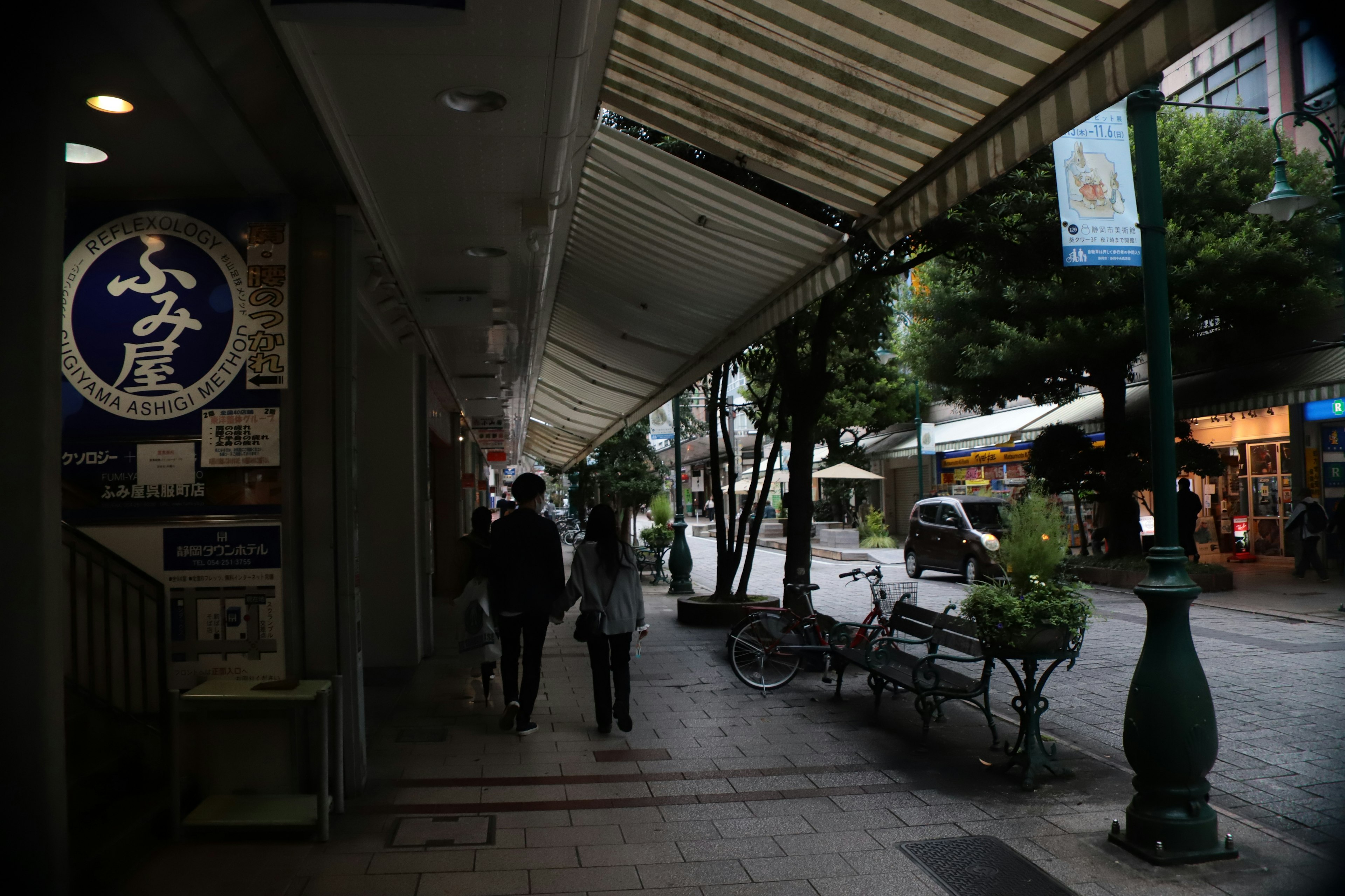 A quiet street scene with pedestrians walking