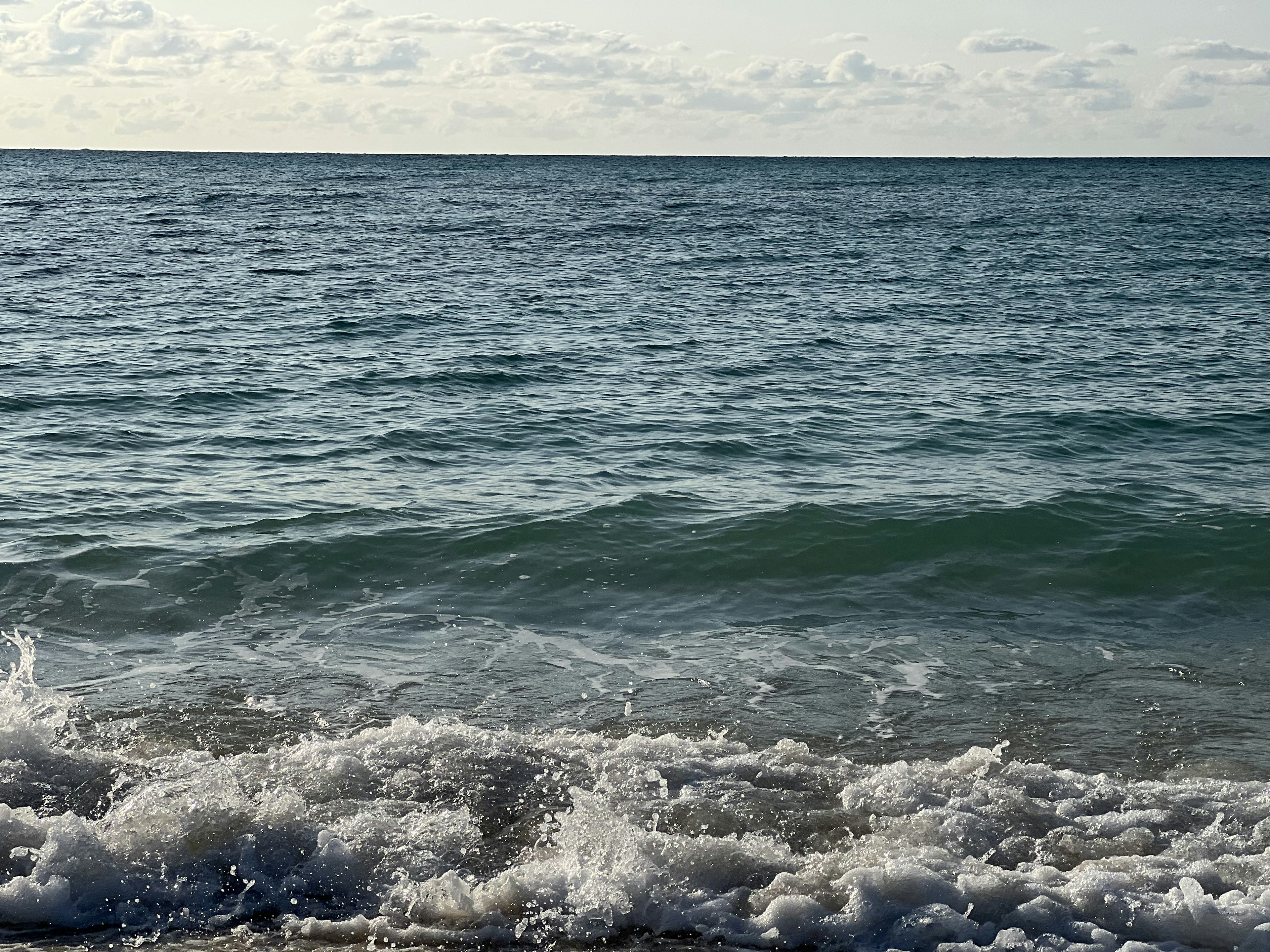 Calm ocean waves with a blue sky