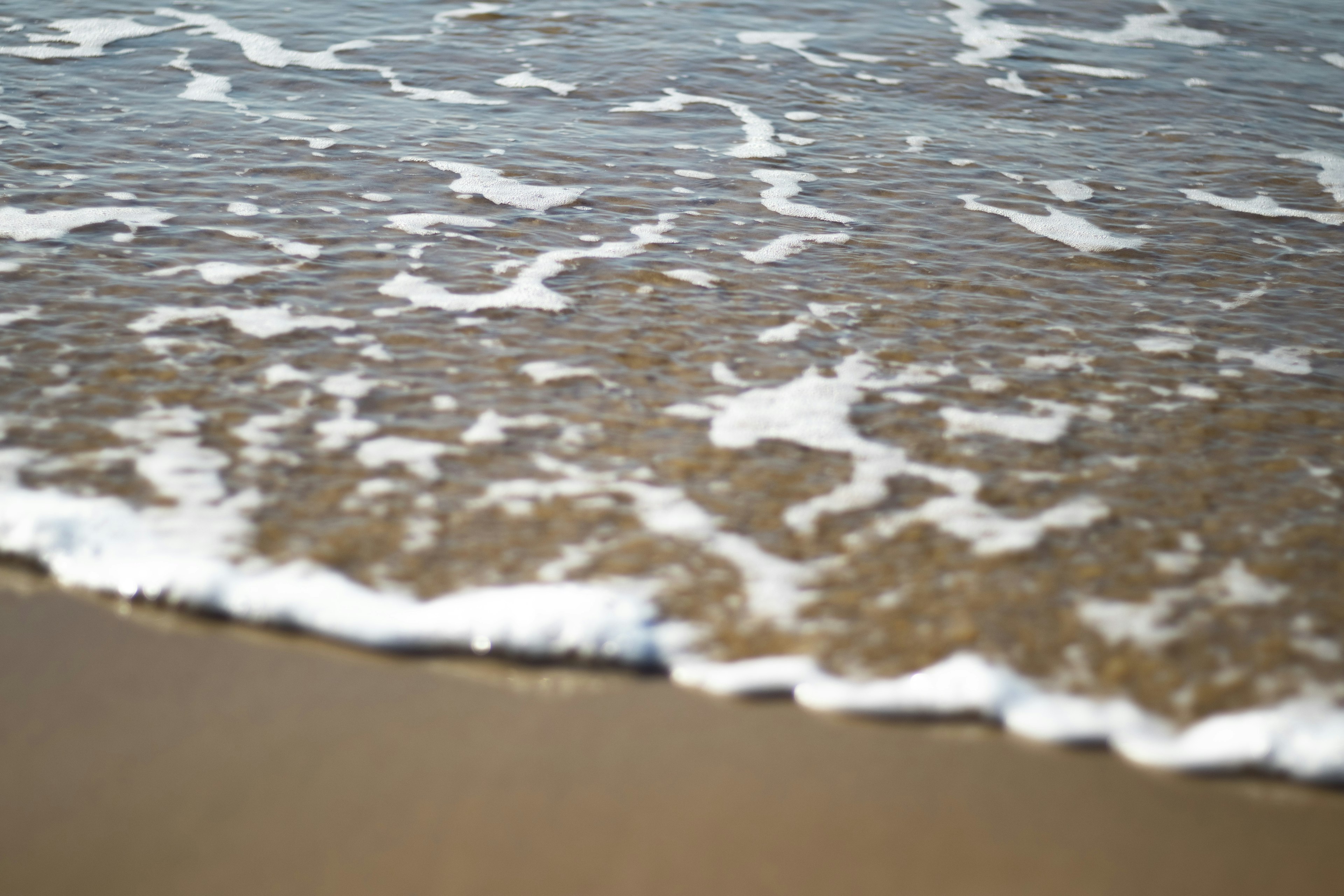 Waves lapping onto a sandy beach