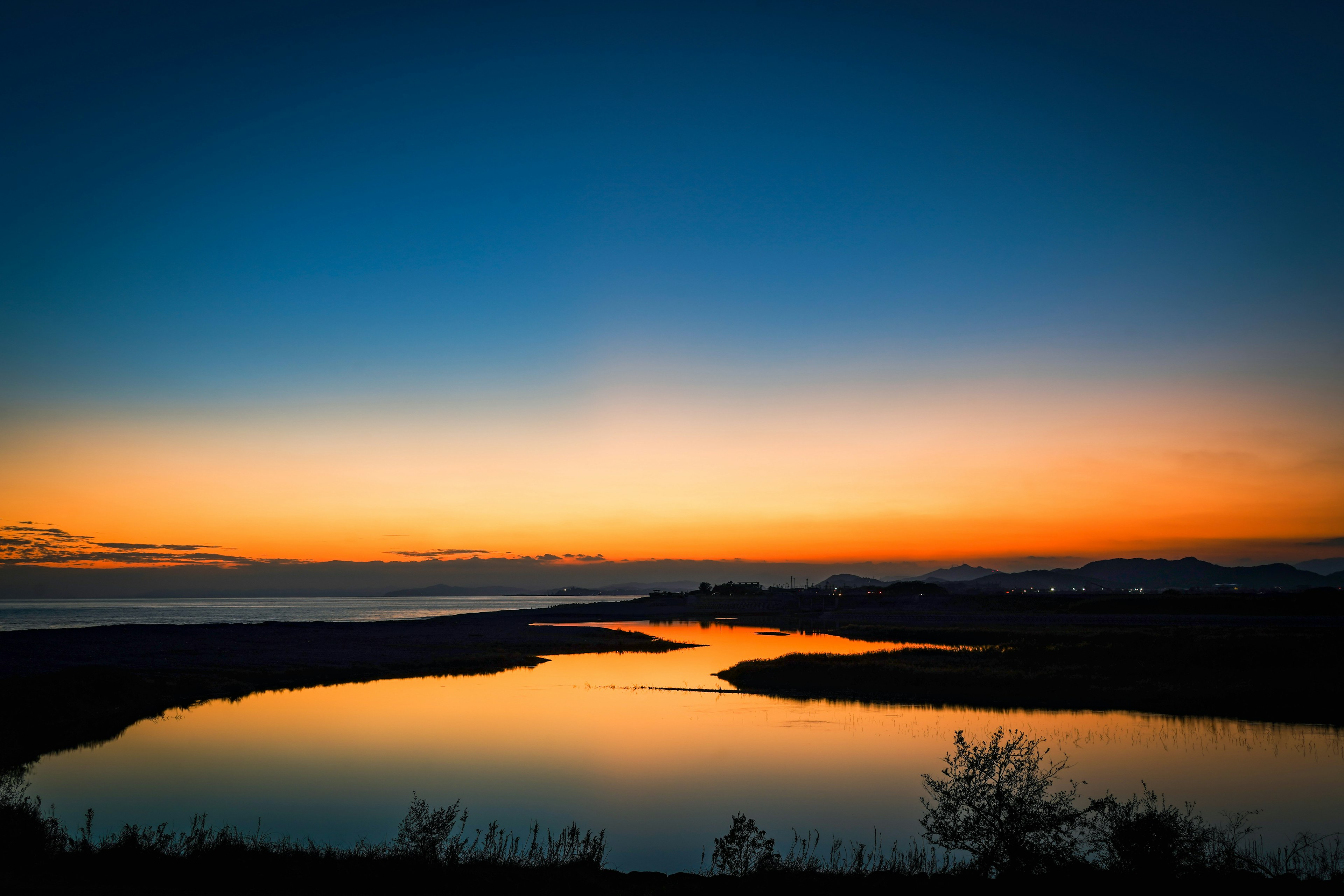 夕焼けの美しい湖の景色青からオレンジへのグラデーション