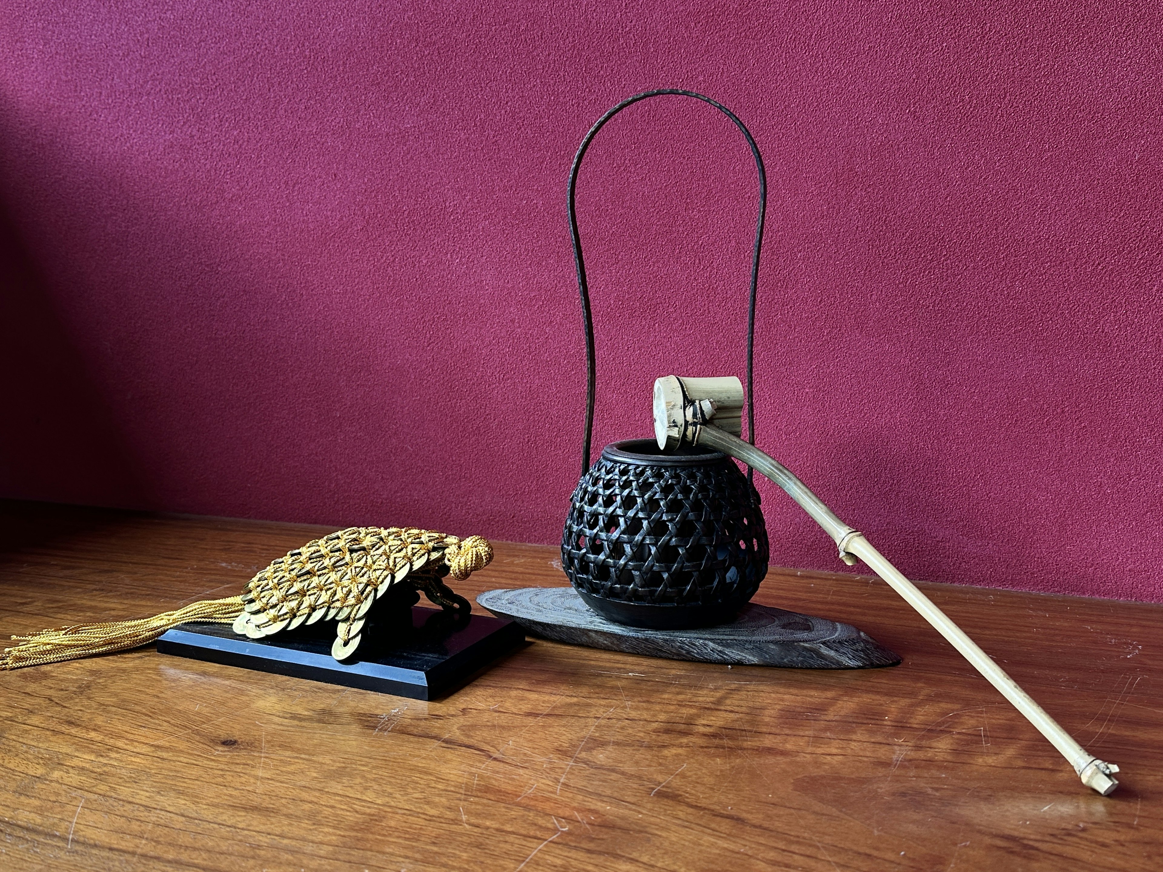 A golden turtle and a black lantern on a wooden table