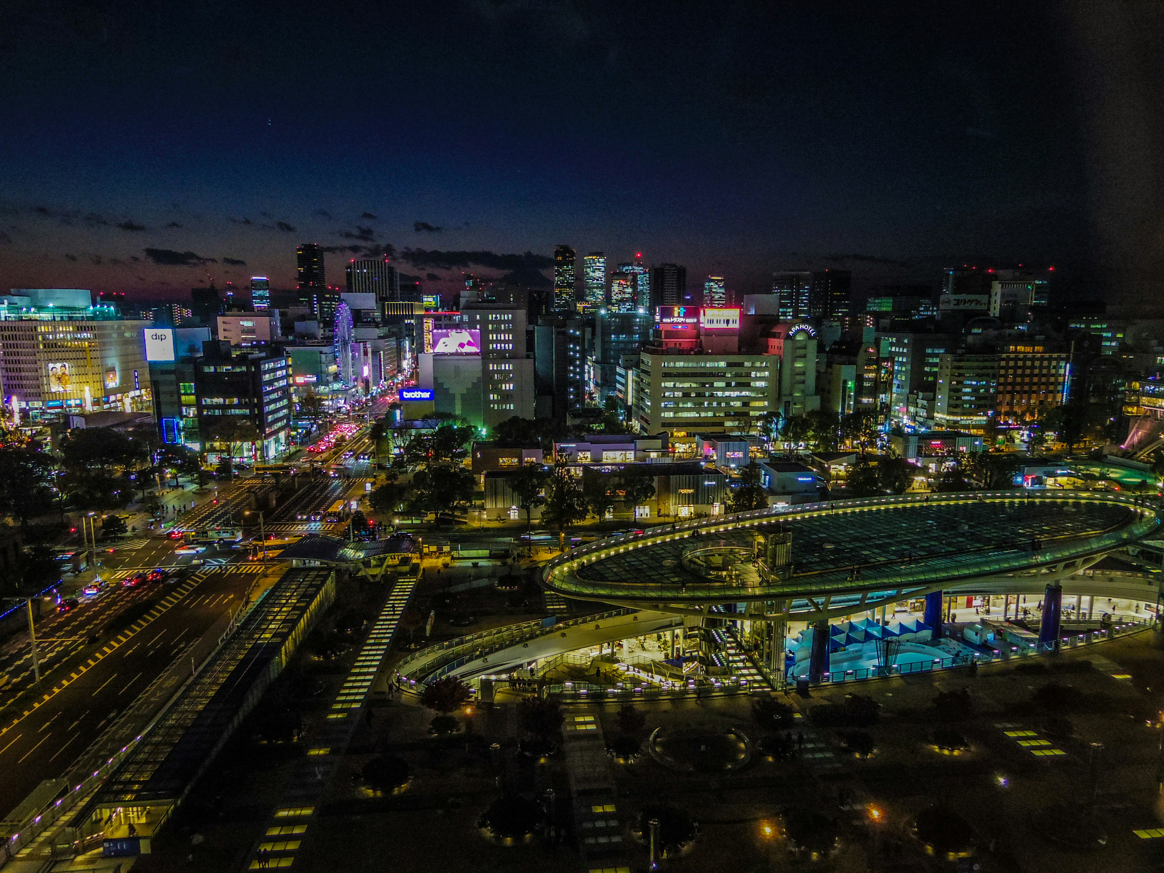 Night cityscape featuring skyscrapers and bright neon lights