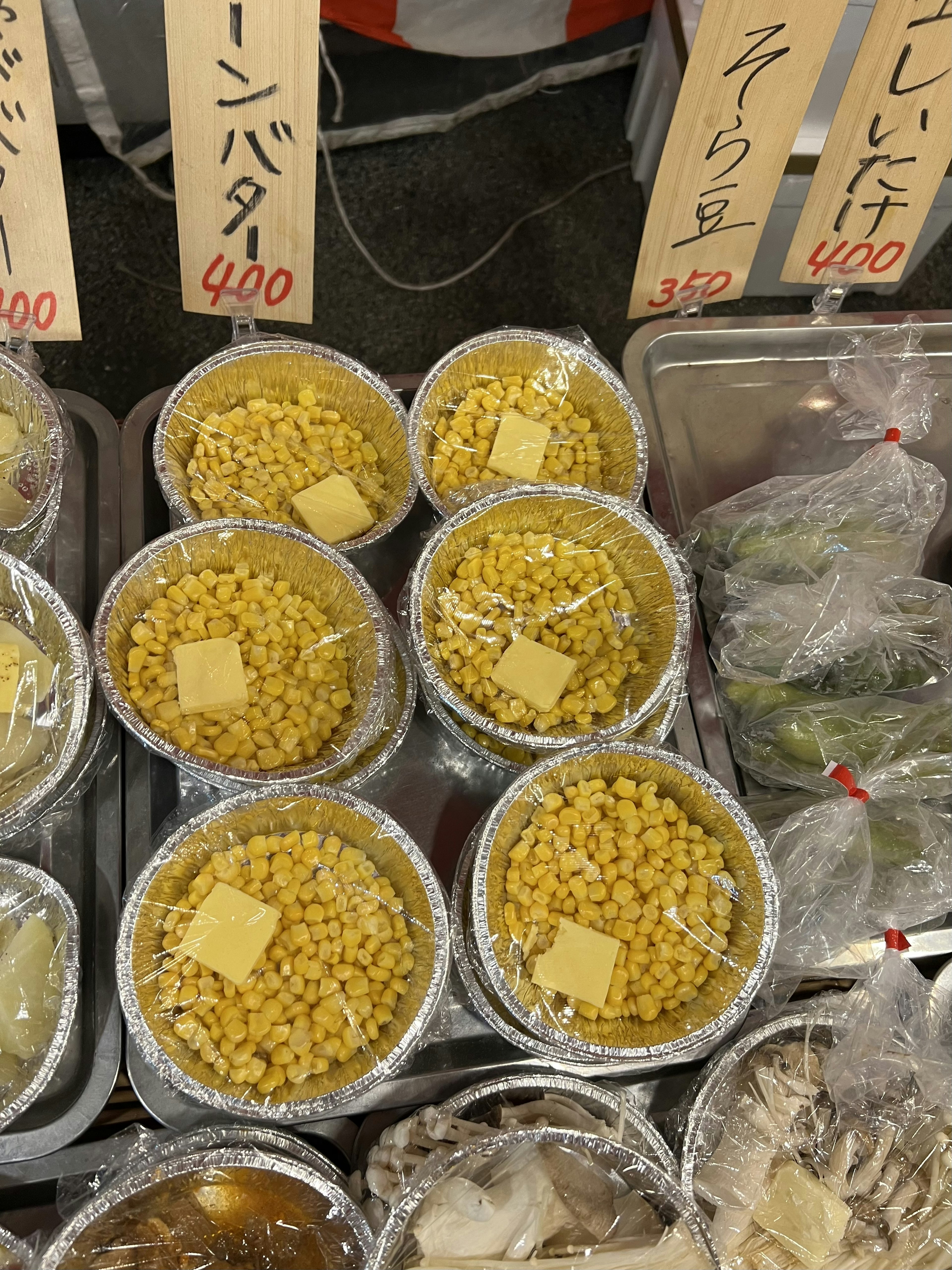 Yellow corn with butter in market containers