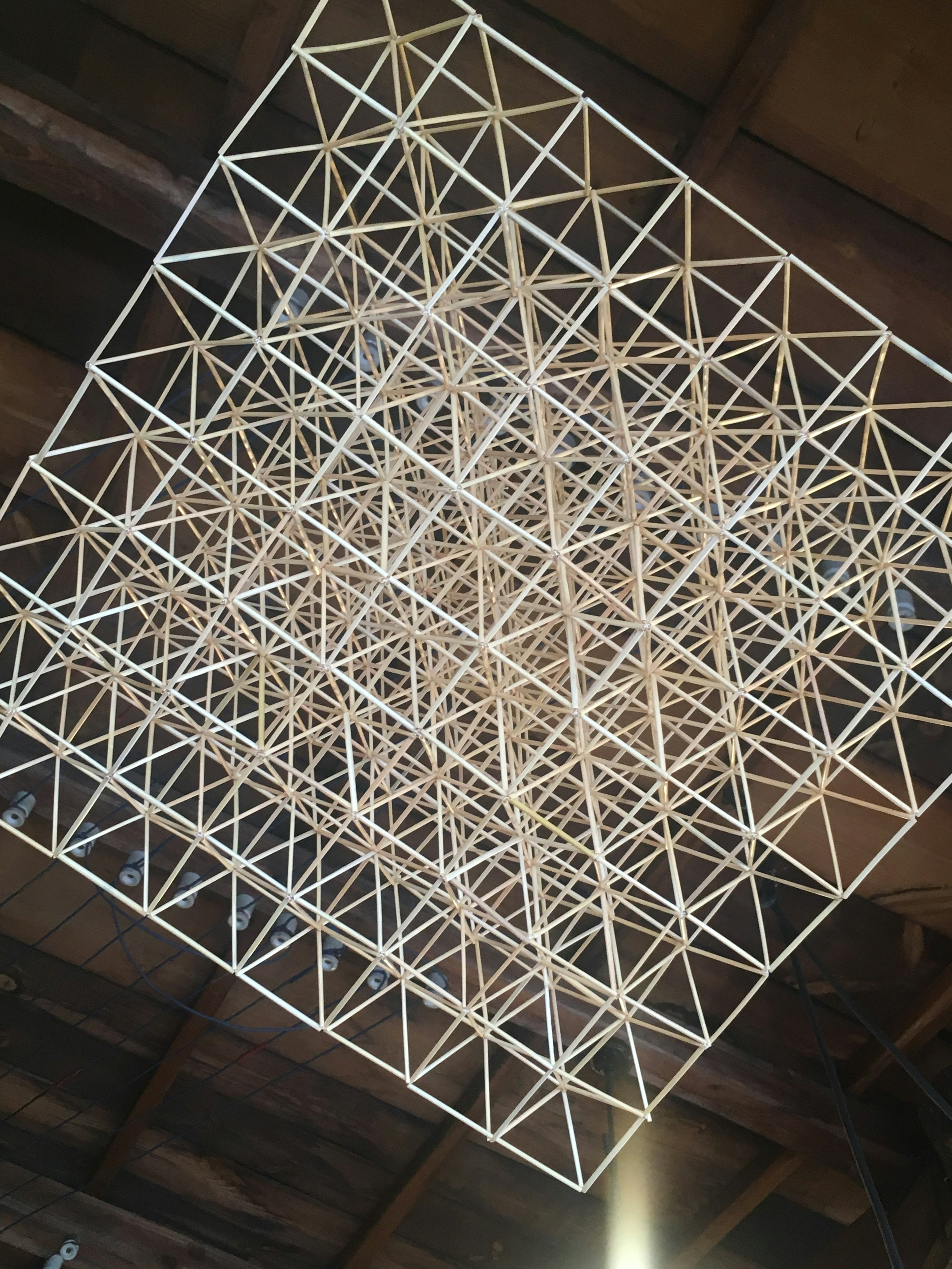 White triangular lattice structure suspended from the ceiling