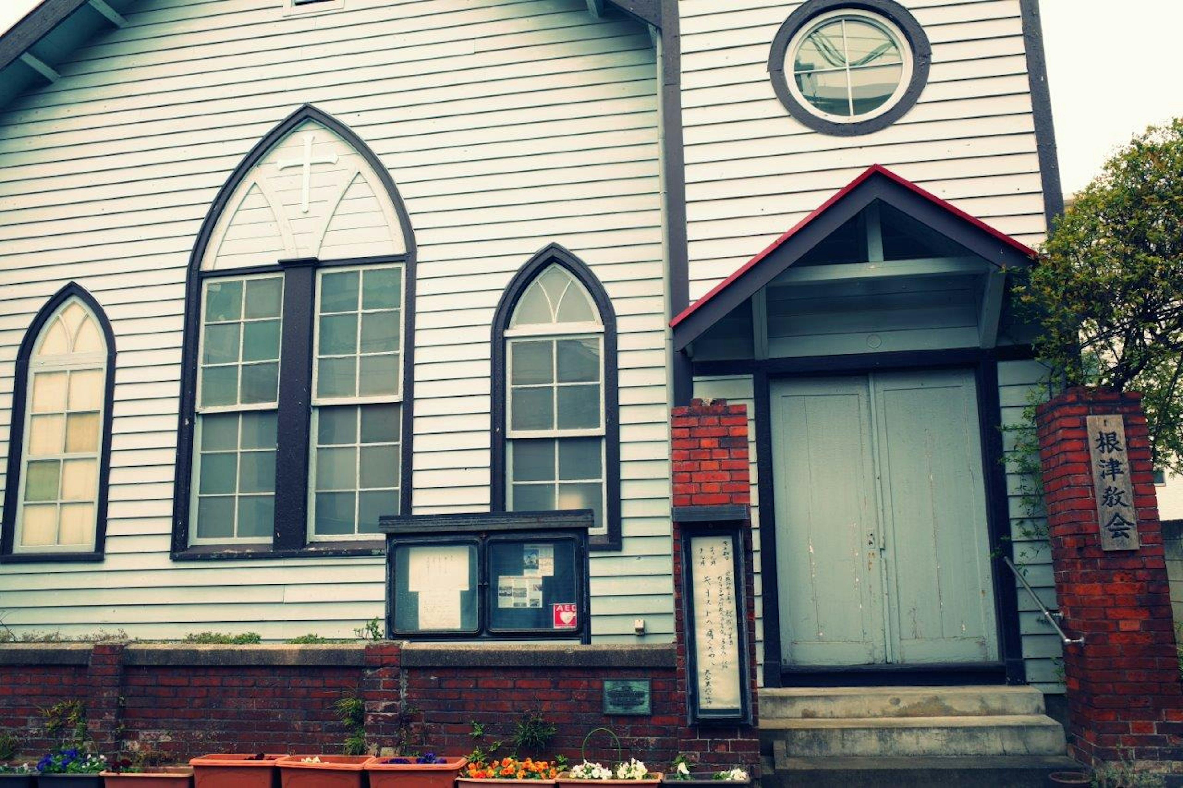 Church building with white and black striped exterior featuring arched windows