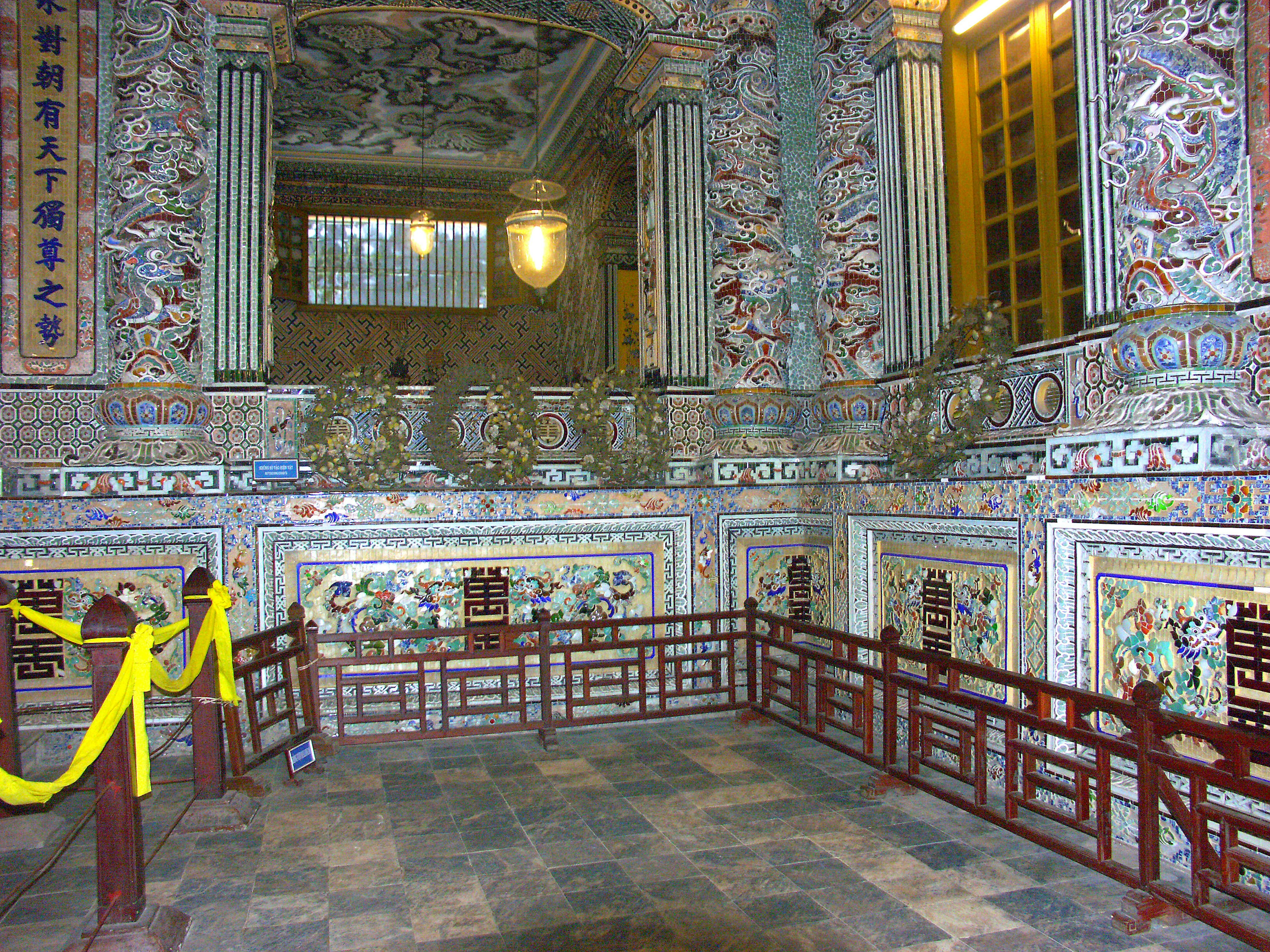 Interior view of a historical room with ornate decorations featuring intricate carvings and colorful tiles