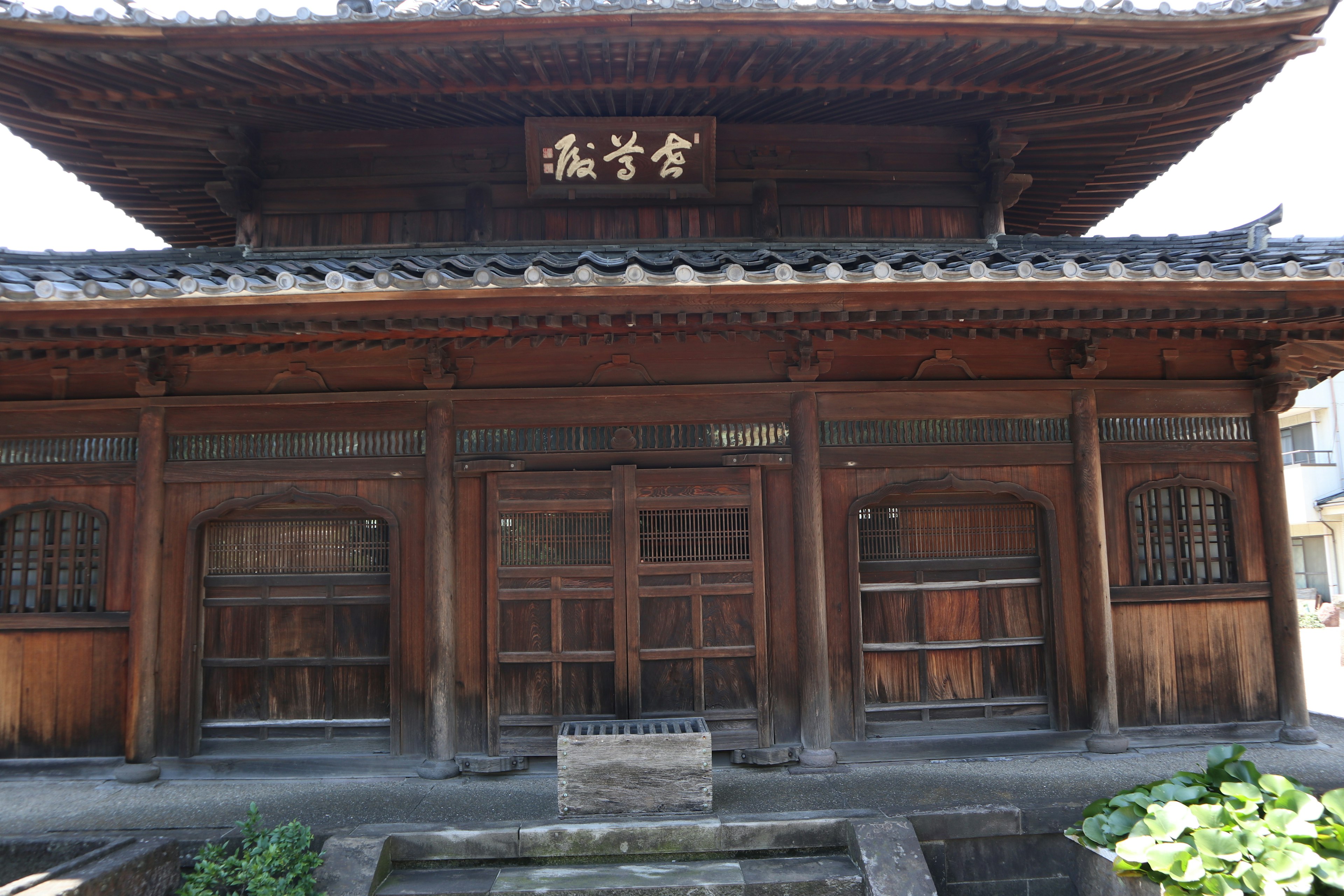 Traditional wooden building facade with intricate design and signage