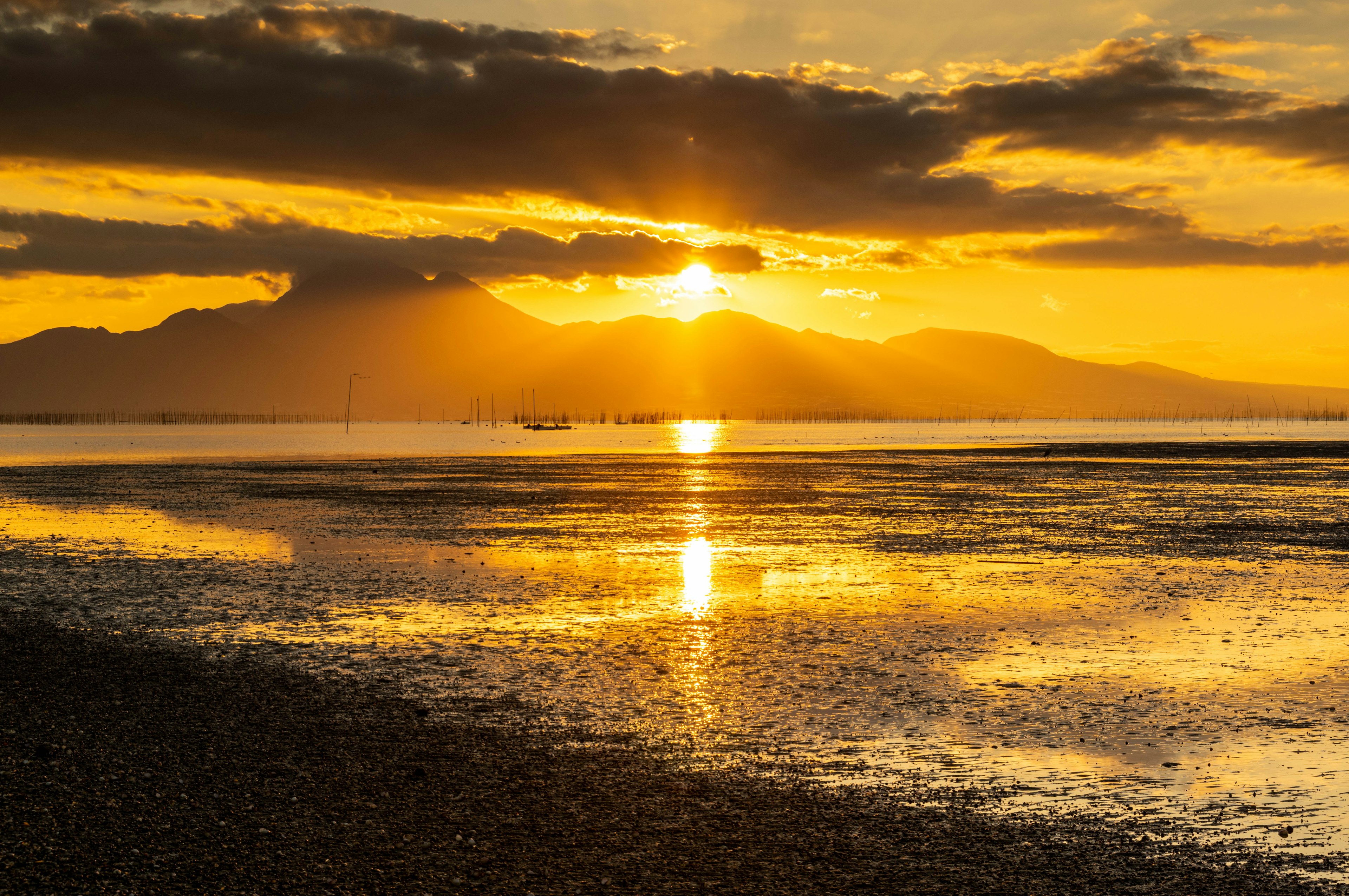 Beautiful landscape with sunset over mountains reflecting on water