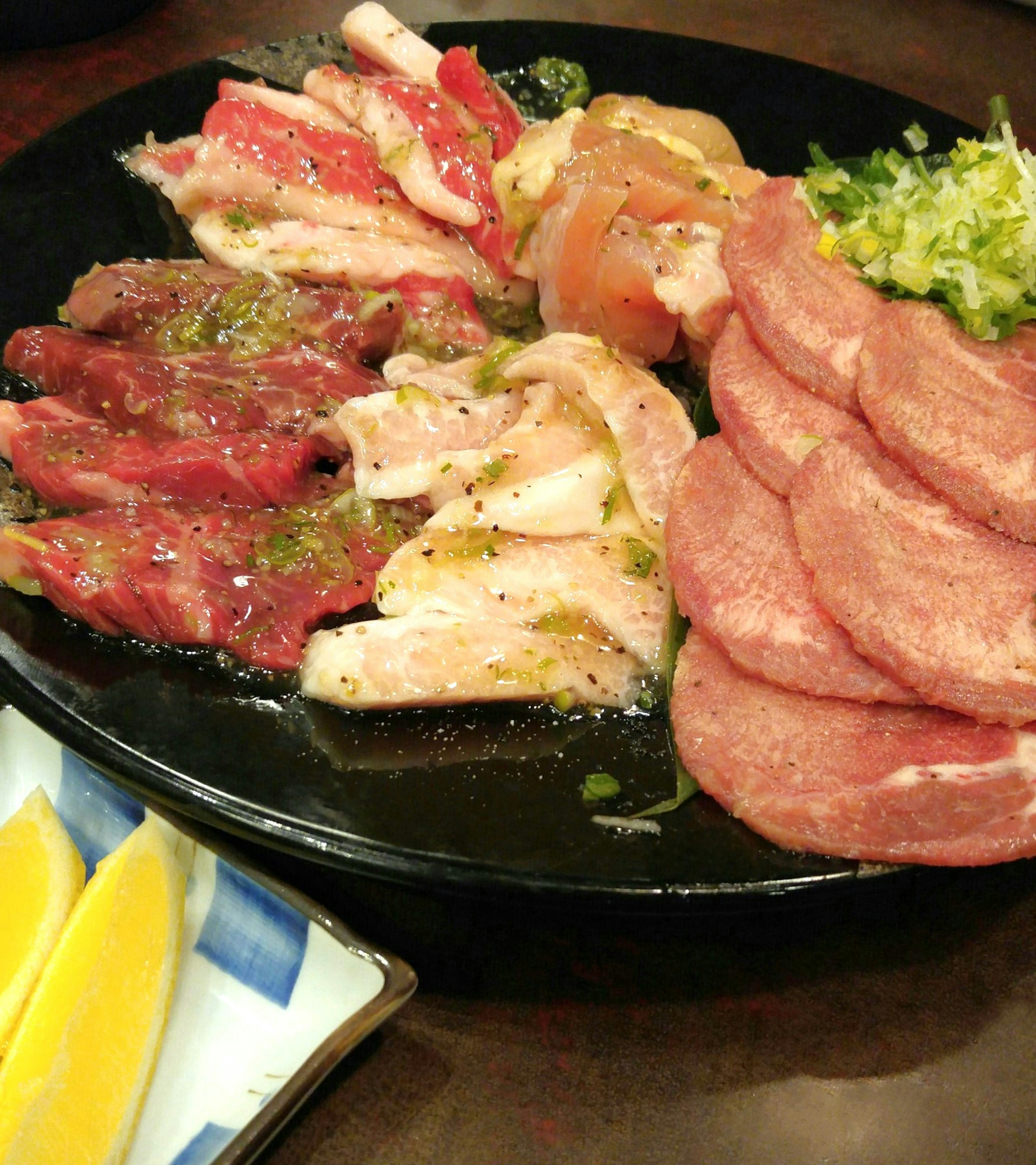 A colorful platter of assorted grilled meats