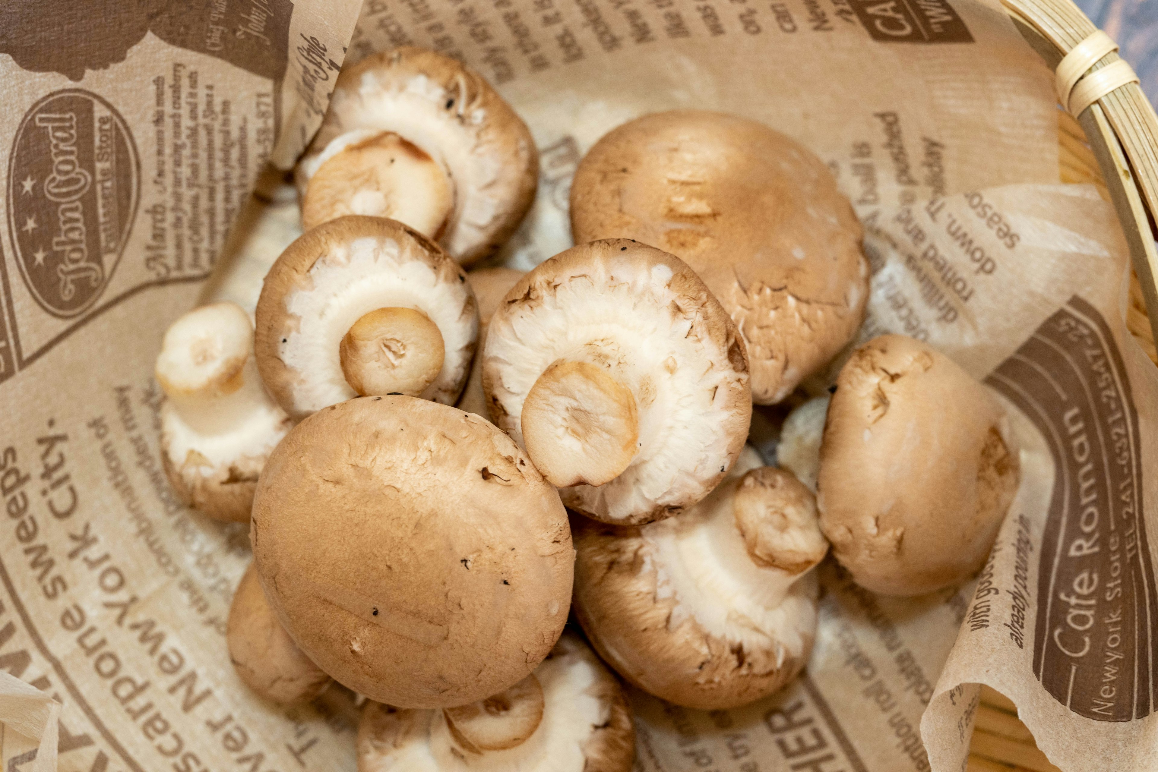 Brown mushrooms arranged in a basket