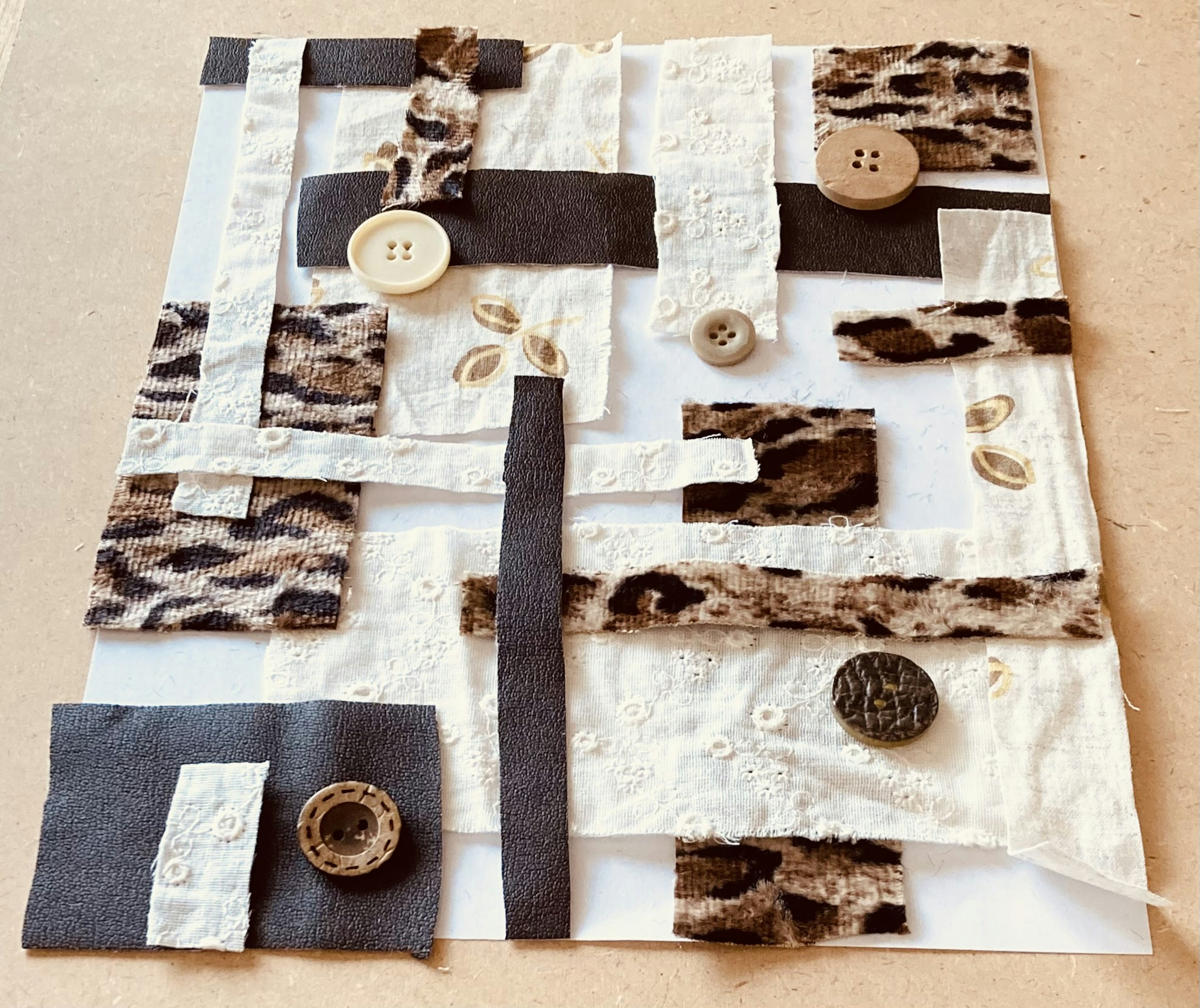 Collage art made with fabric and buttons