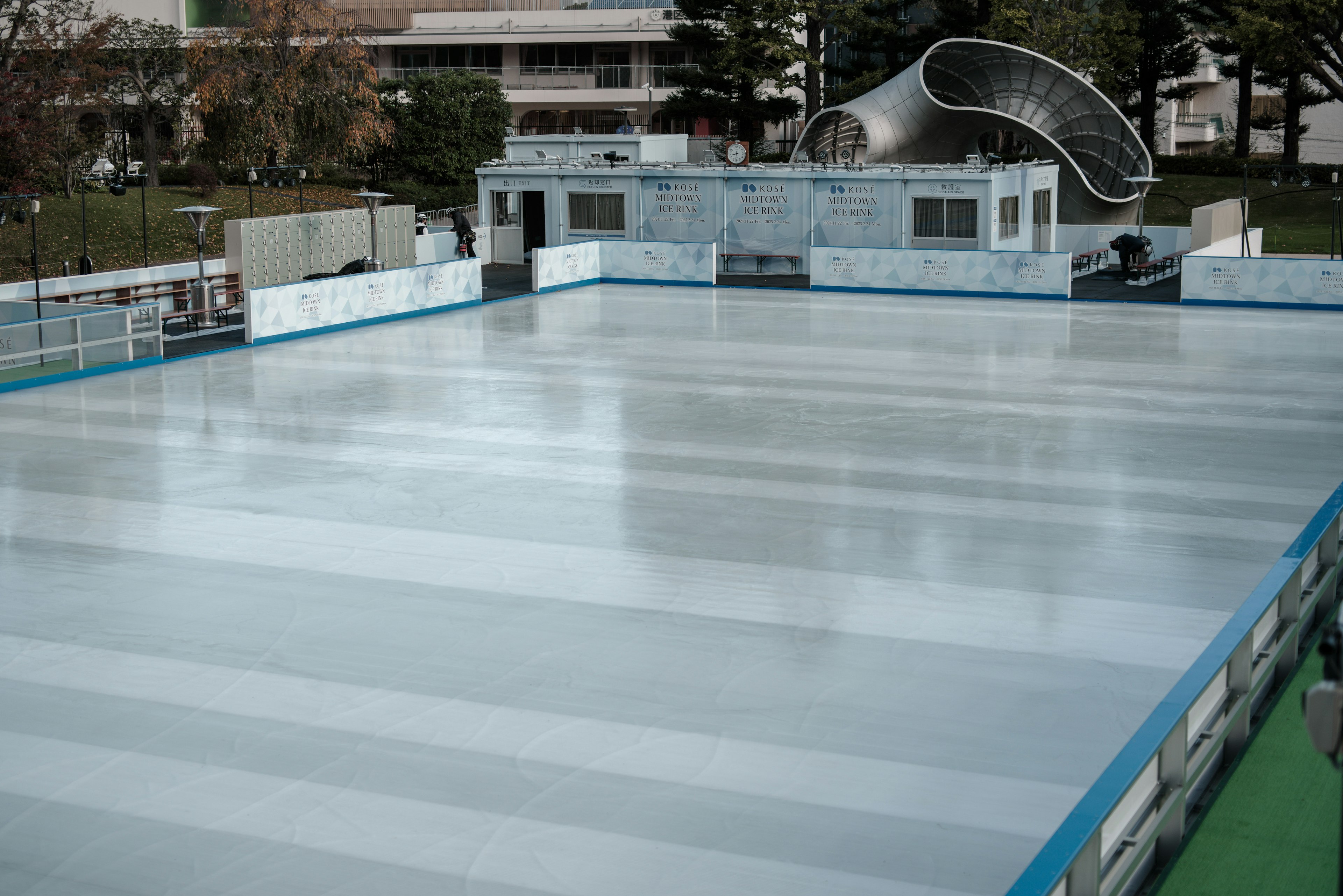 Ice skating rink with smooth surface and surrounding structures