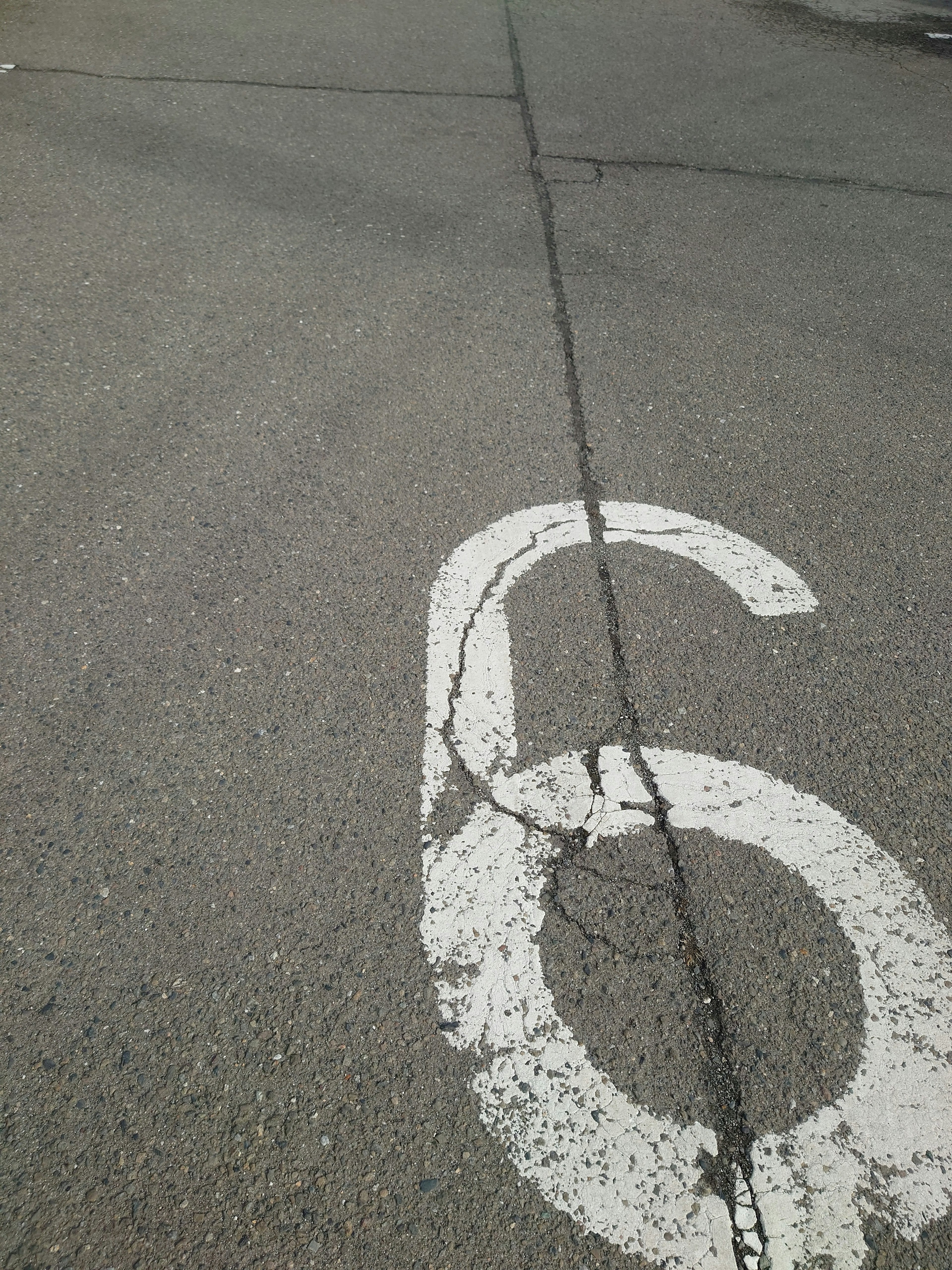 White number 6 painted on asphalt road