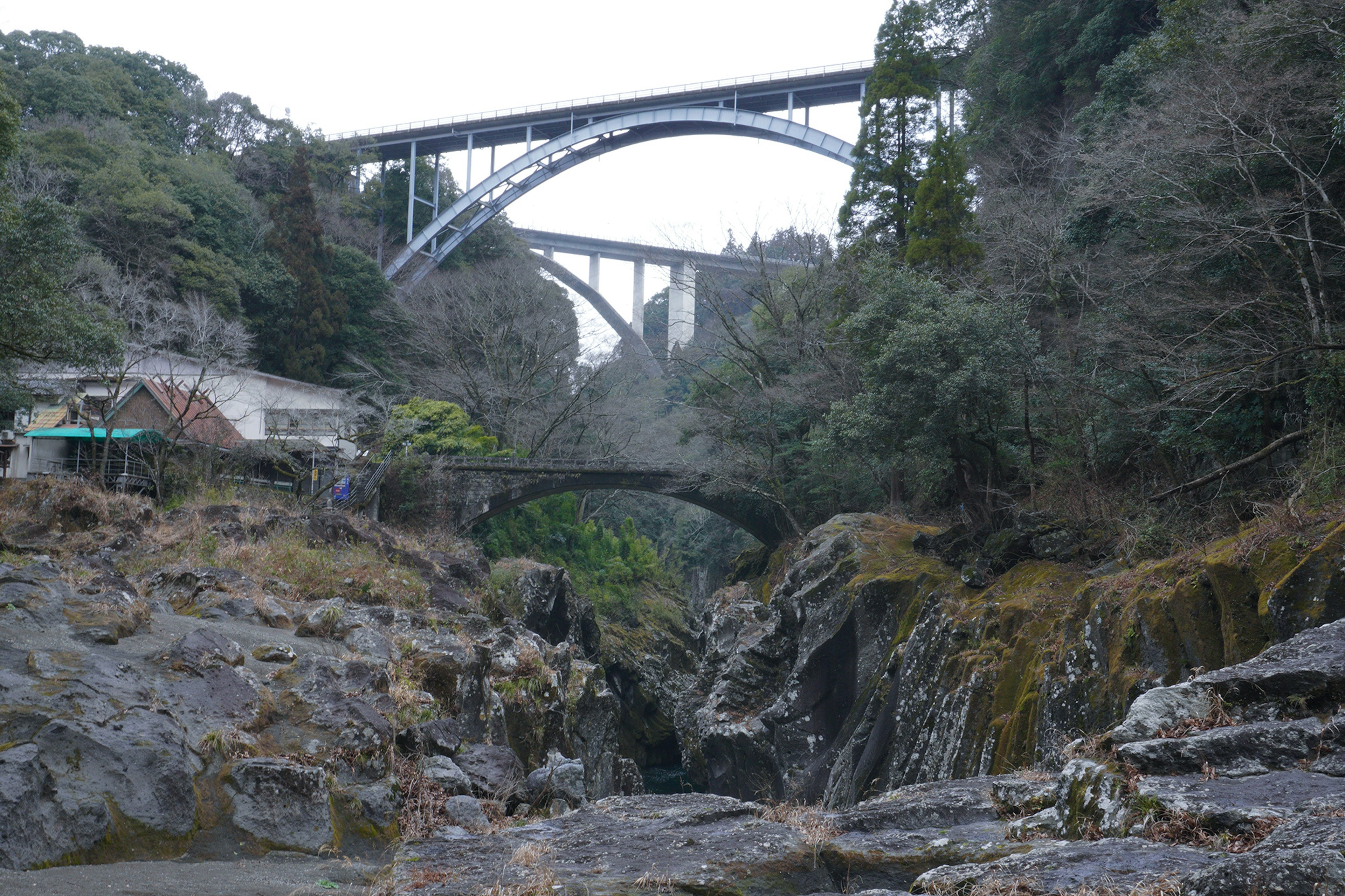 Scenic view of a valley surrounded by bridges and rocky terrain