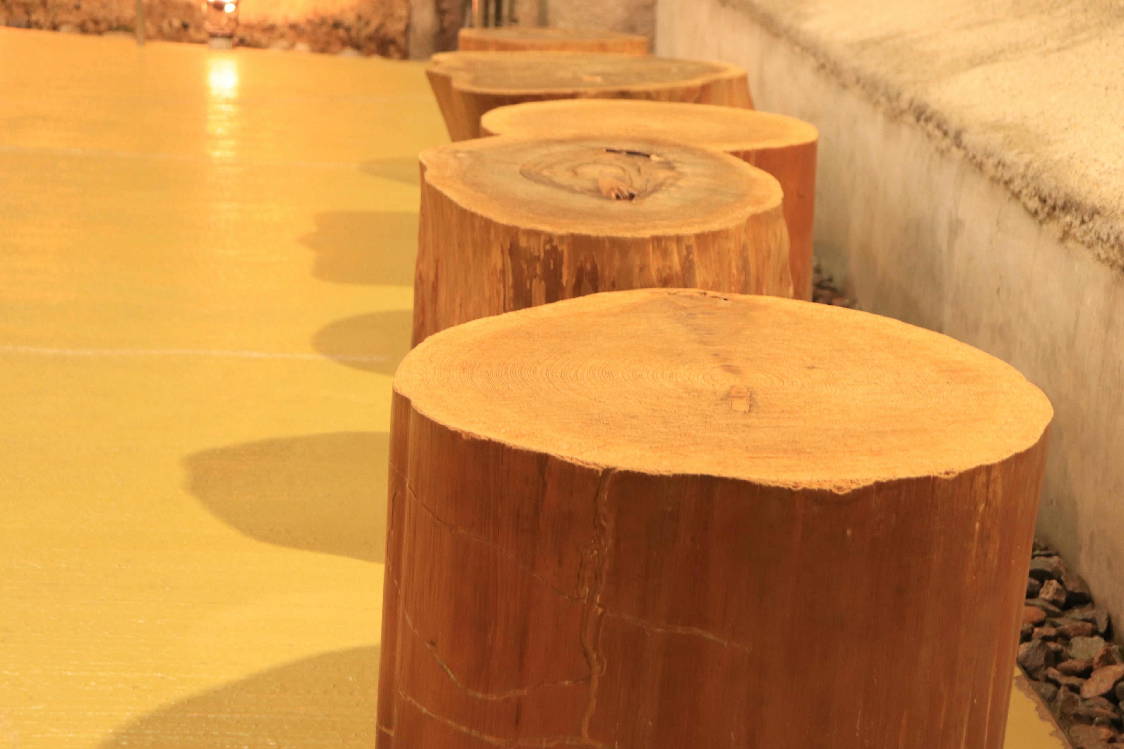 Wooden logs arranged on a bright yellow floor